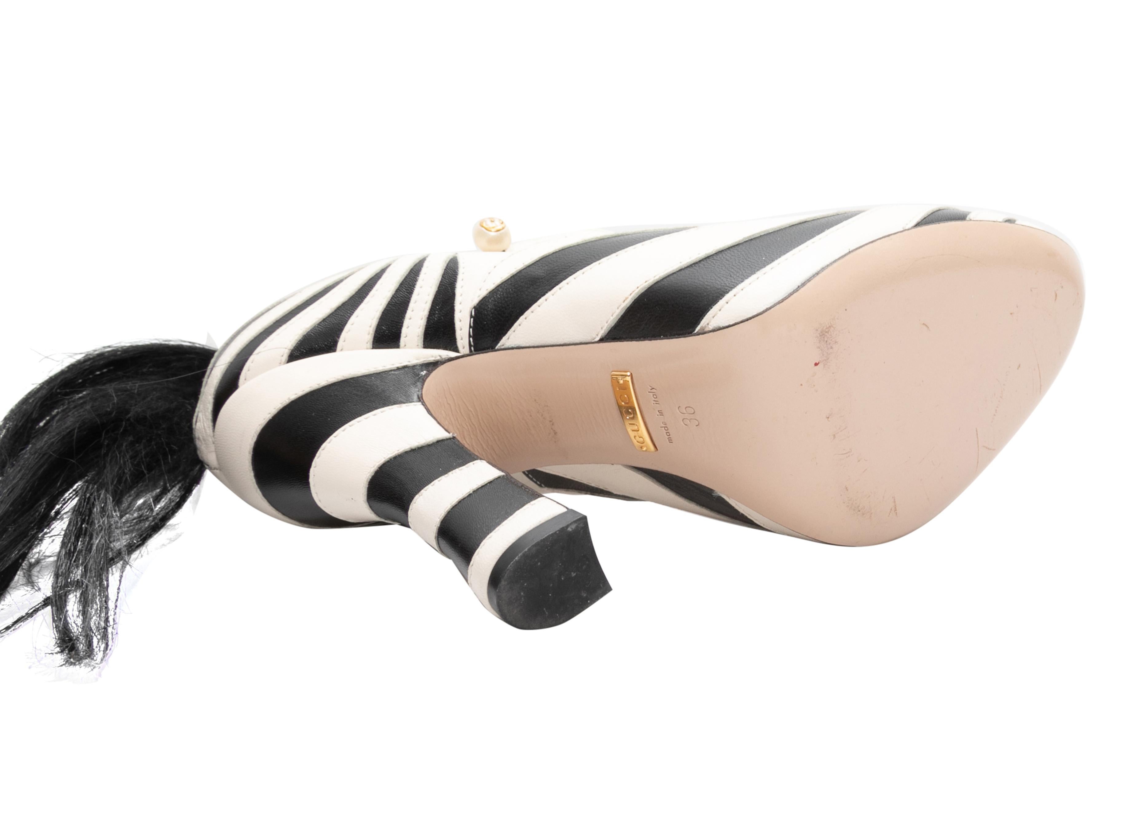 Black and white leather Mary Jane zebra pumps by Gucci. From the 2017 Alessandro Michele Era. Tail accents at counters. 4.75