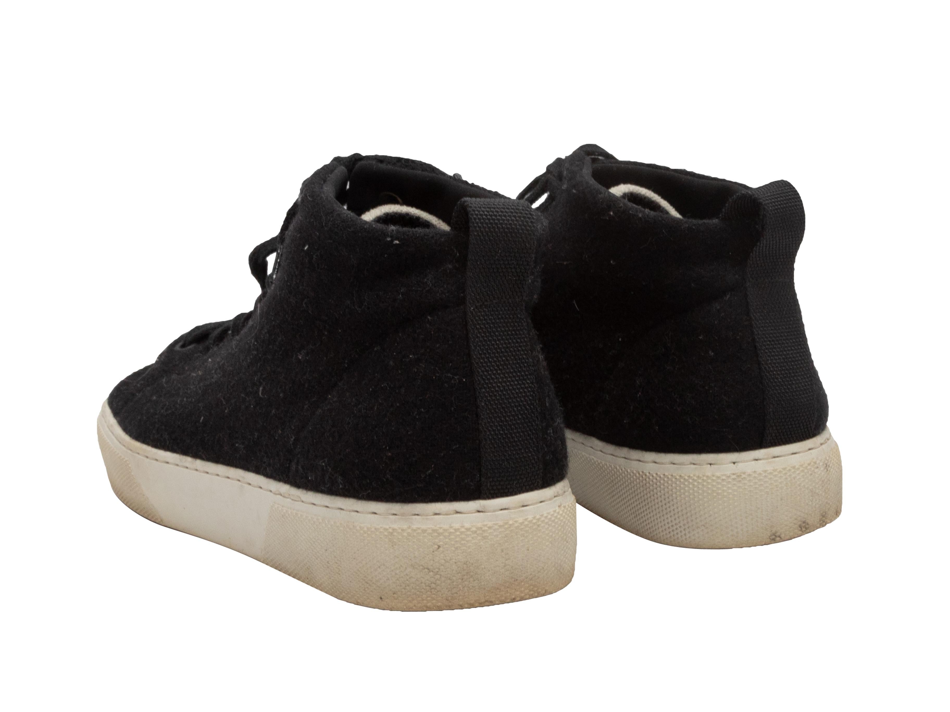 Product Details: Black and white wool high-top sneakers by James Perse. Rubber soles. Lace-up tie closures at tops. 2.75
