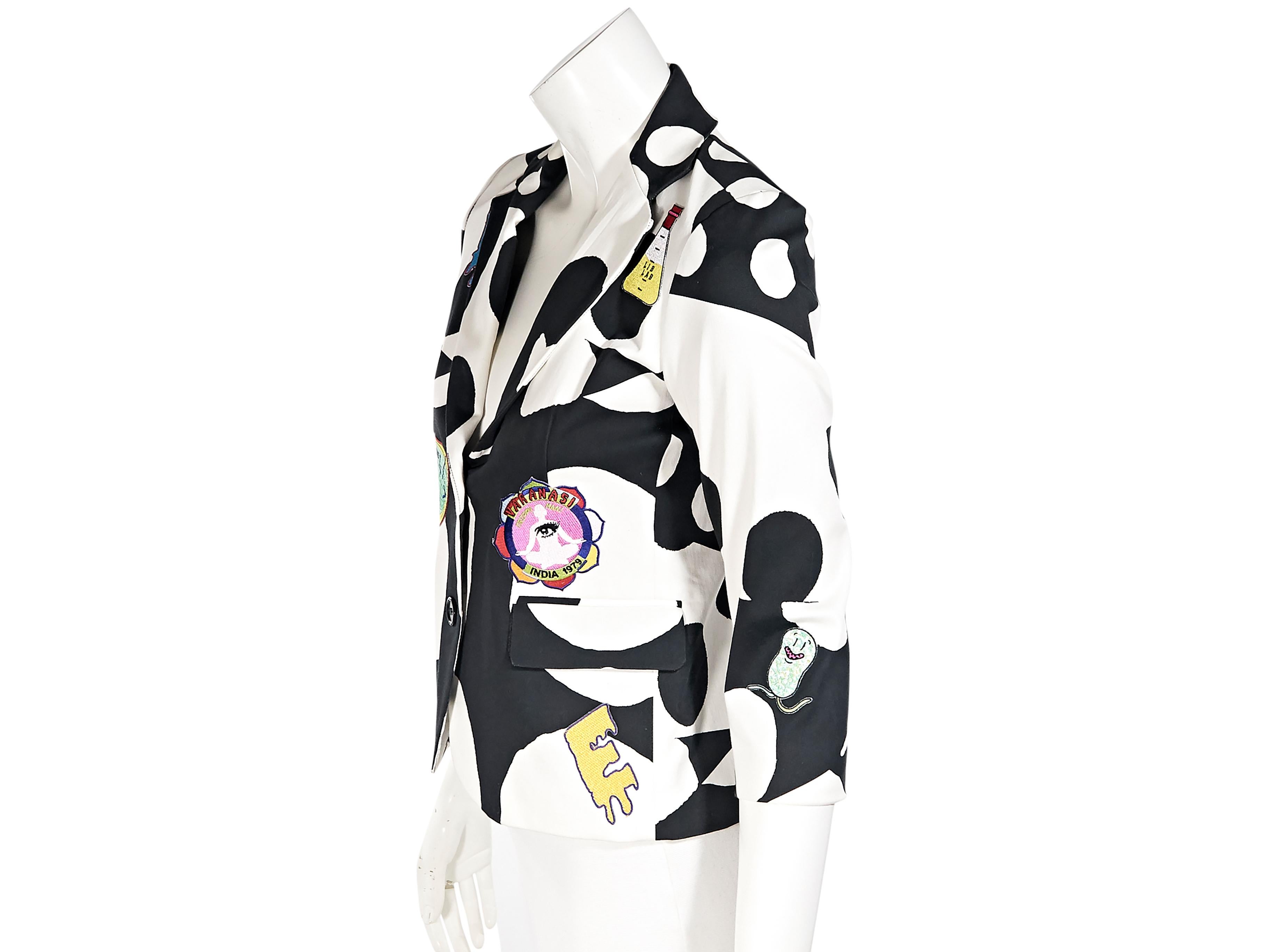 Product details:  Black and white printed blazer by Libertine.  Accented with multicolor patches.  Notched lapel.  Three-quarter length sleeves.  Button-front closure.  Waist flap pockets.  Back center hem pleat.  28