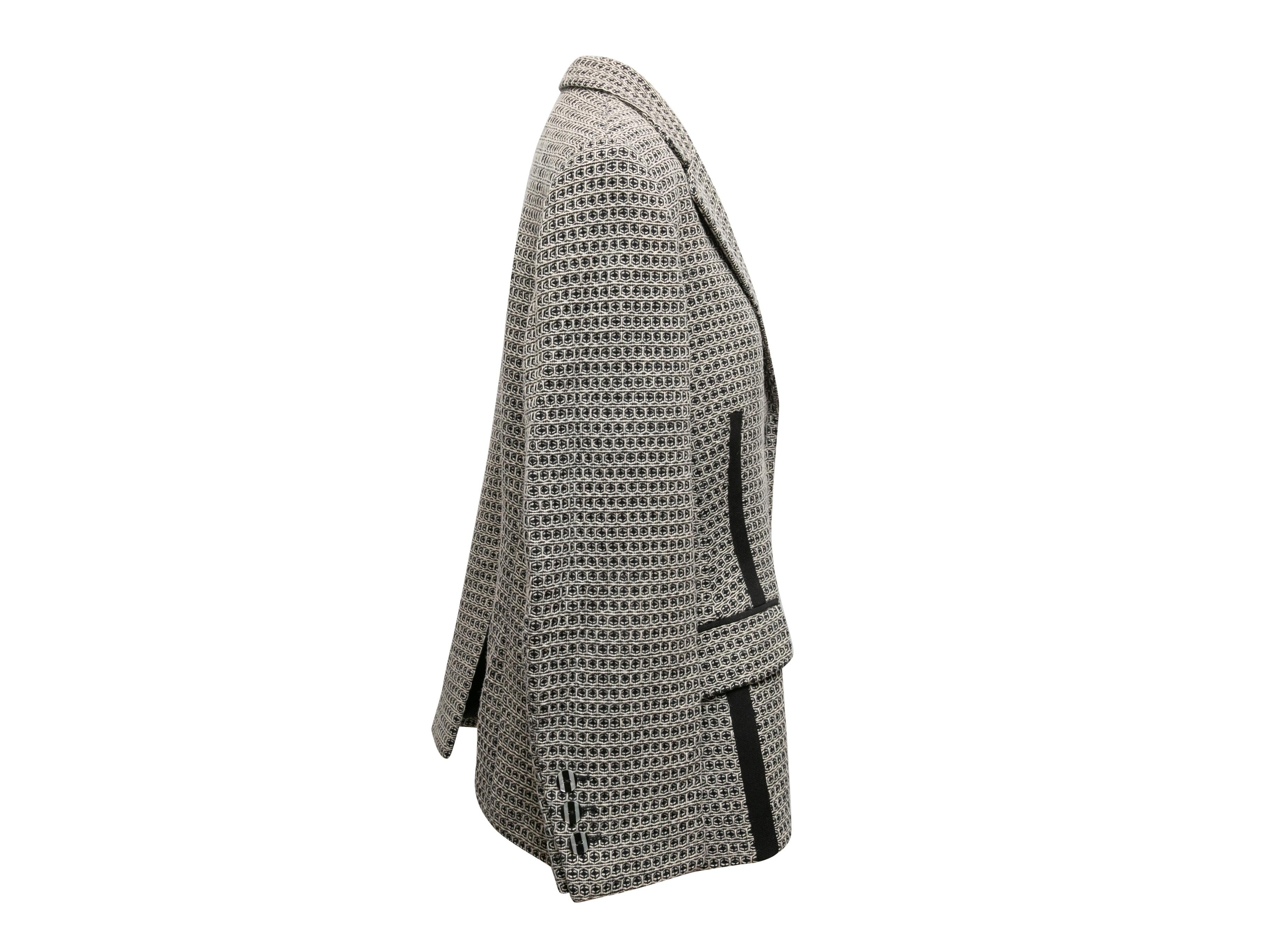  Black and white virgin wool patterned blazer by Louis Feraud. Notched lapel. Dual hip pockets. Front button closures. 43