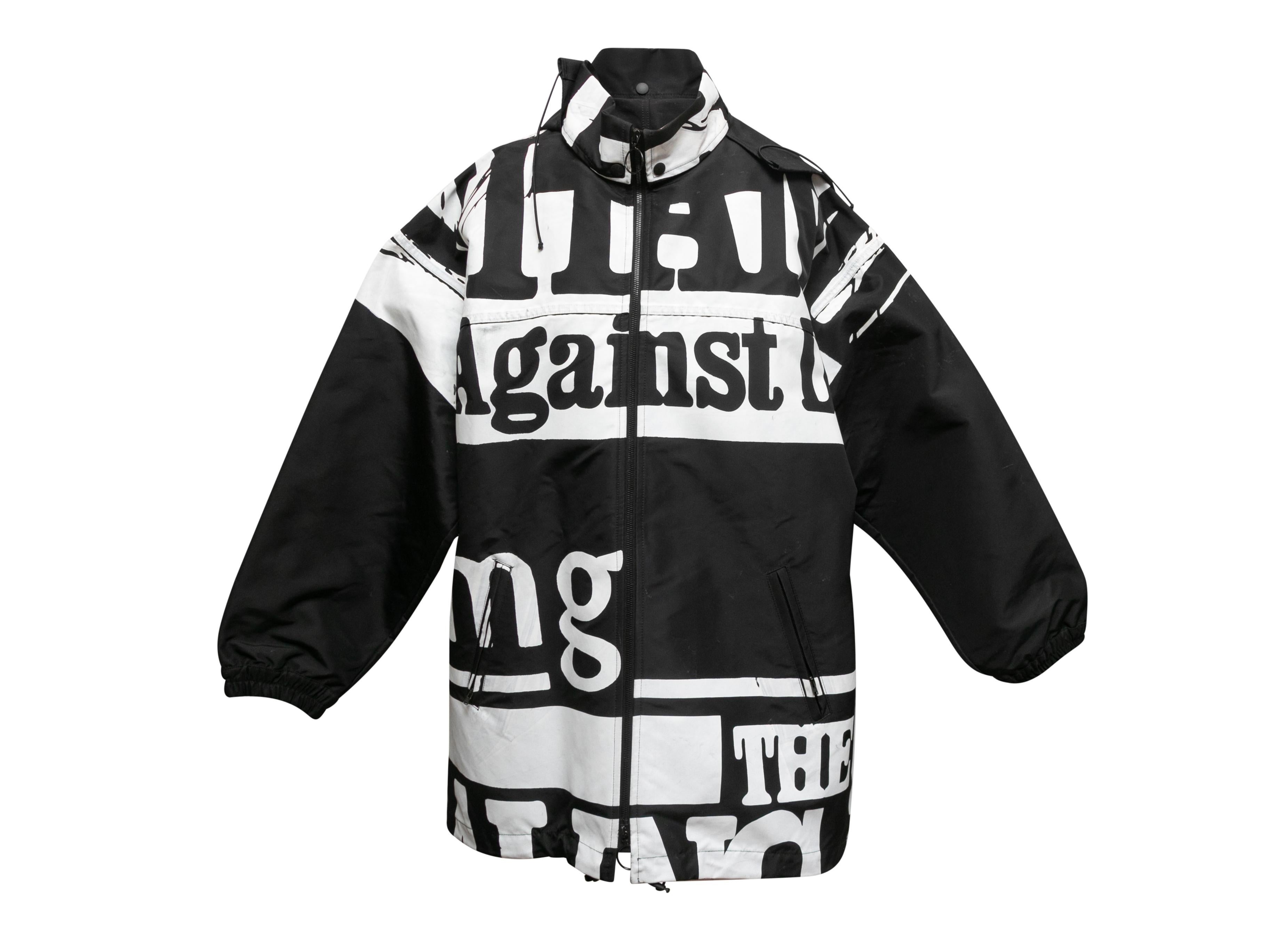 Black and white graphic text print parka by Maison Margiela. Stand collar. Dual hip pockets. Zip closure at center front. 48