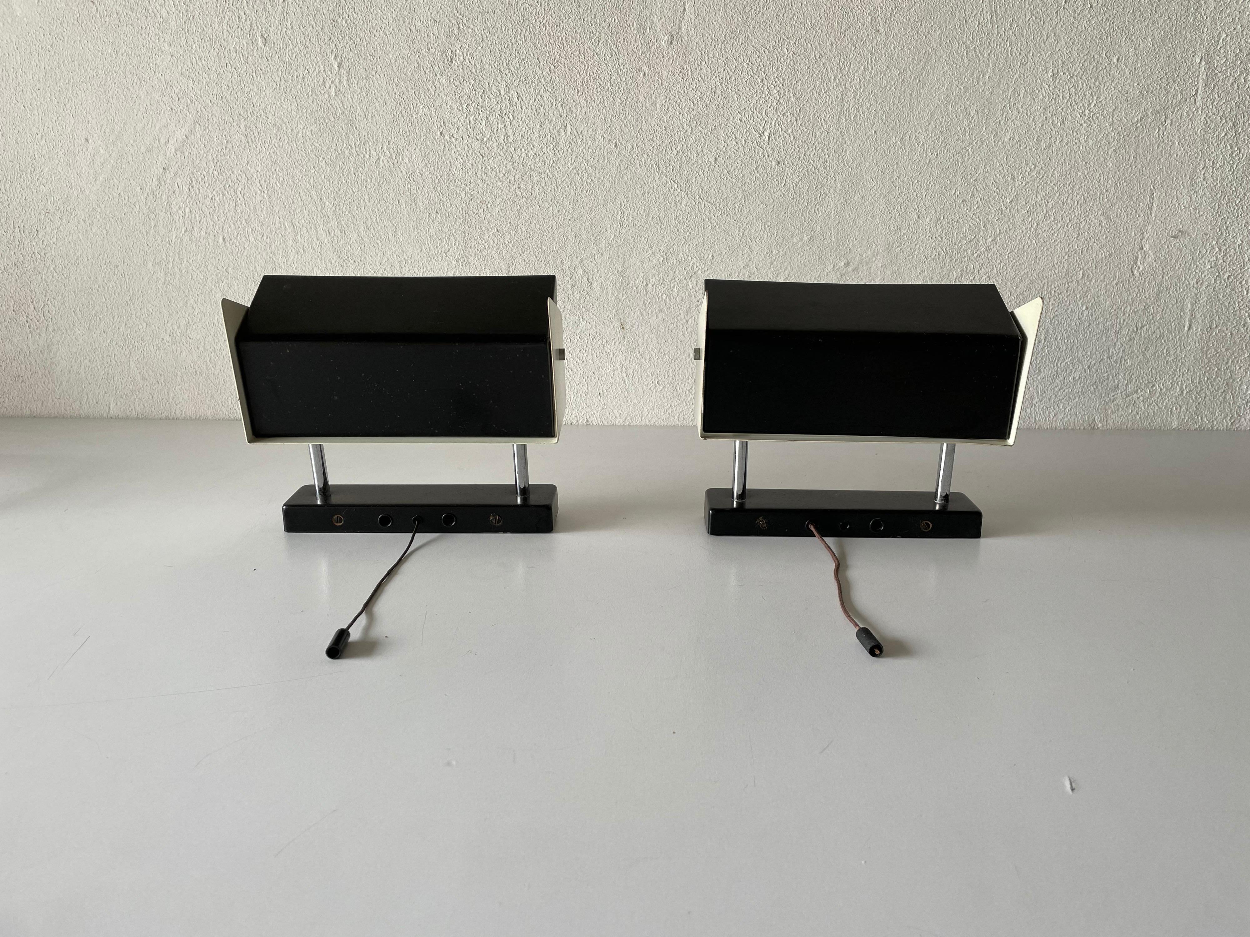 Black-white metal adjustable shade Industrial pair of sconces by Staff, 1950s, Germany

Adjustable Reflectors

Very elegant and Minimalist wall lamps.
There are two switch on-off ropes 

Lamps are in very good condition.

These lamps works
