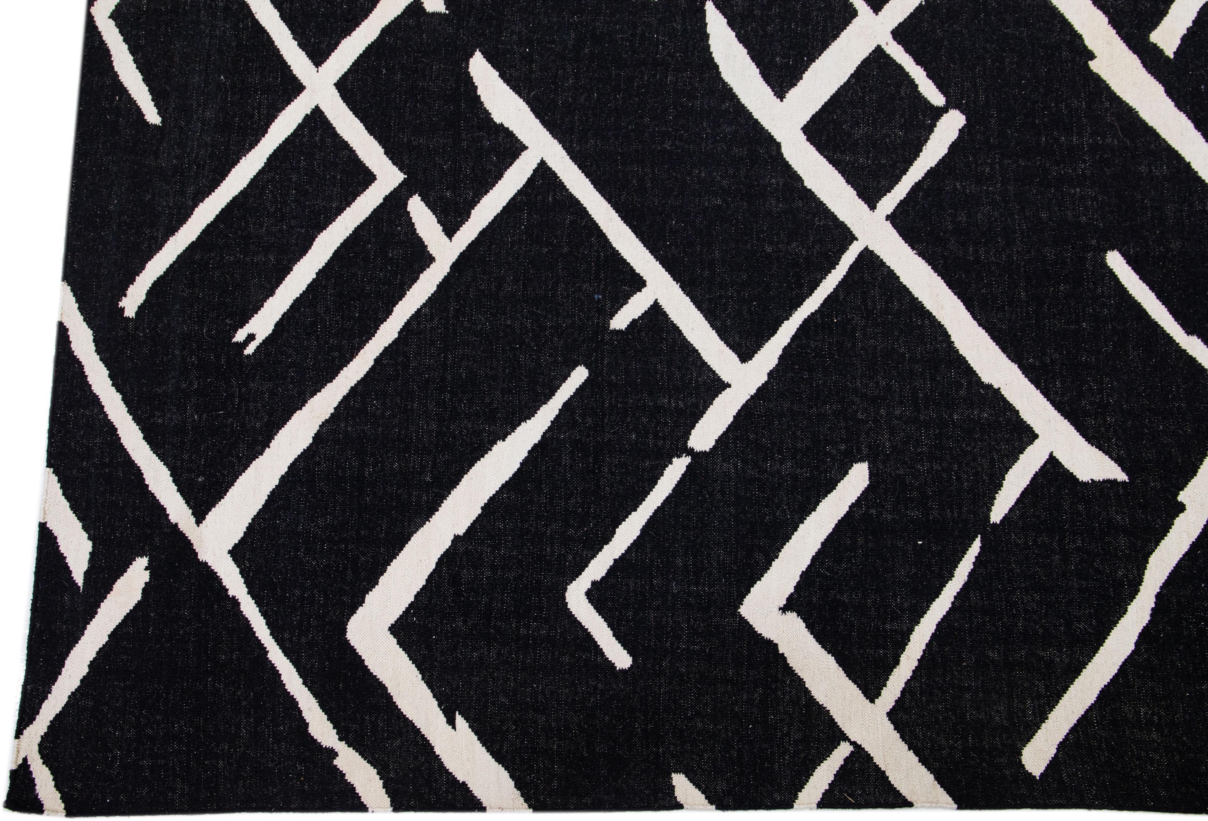 Beautiful Modern Kilim flatweave wool rug with black and white color field features a gorgeous allover geometric motif. 

This rug measures: 10'3