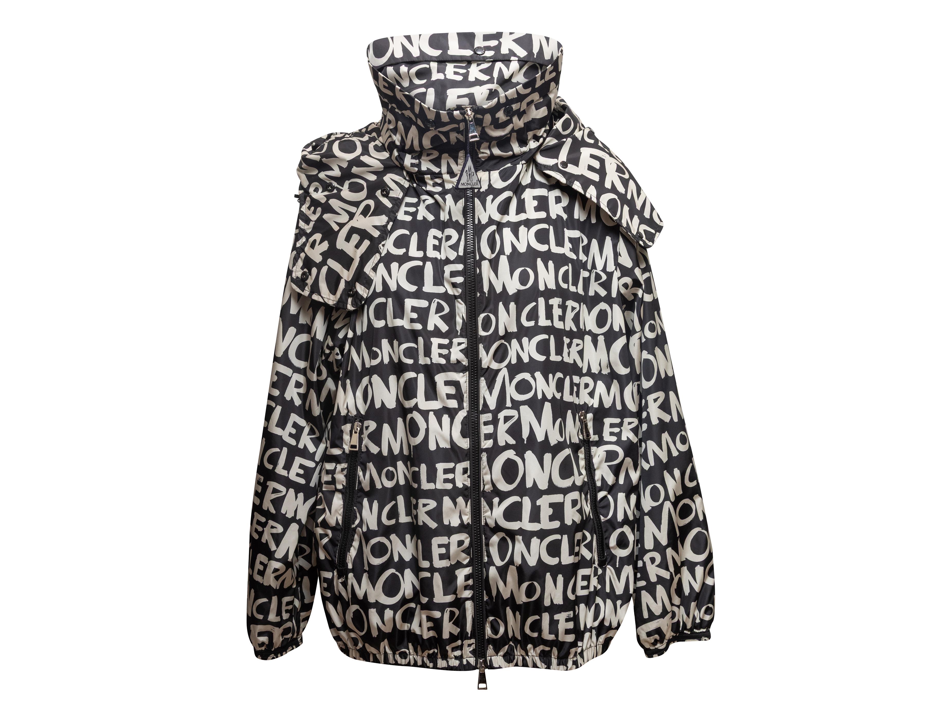 Black and white logo print hooded windbreaker jacket by Moncler. Stand collar. Dual hip pockets. Front zip closure. 40
