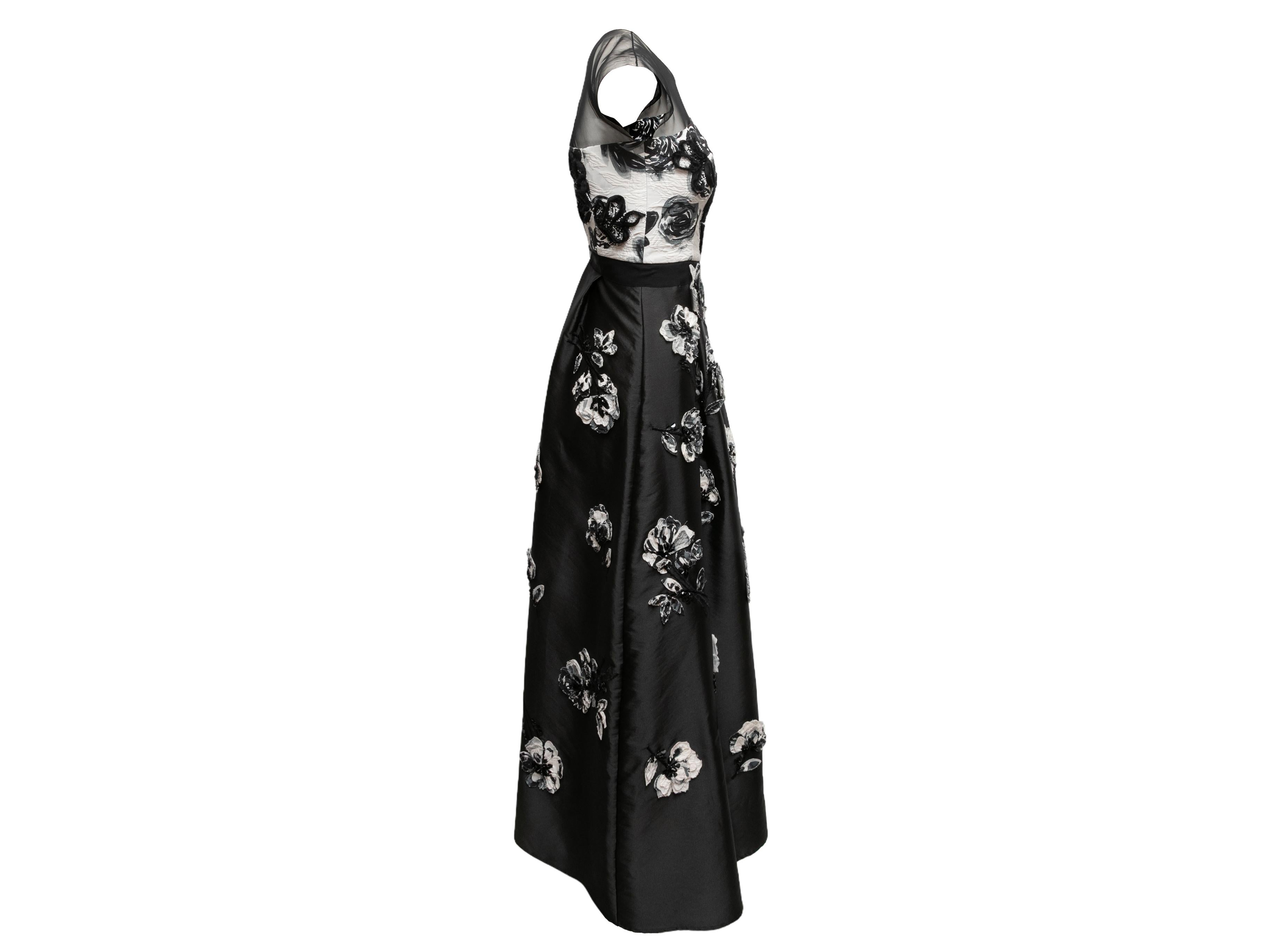 Black and white sleeveless floral applique evening dress by Sachin & Babi Noir. Crew neck. Sheer mesh panel at shoulders. Zip closure at back. 28
