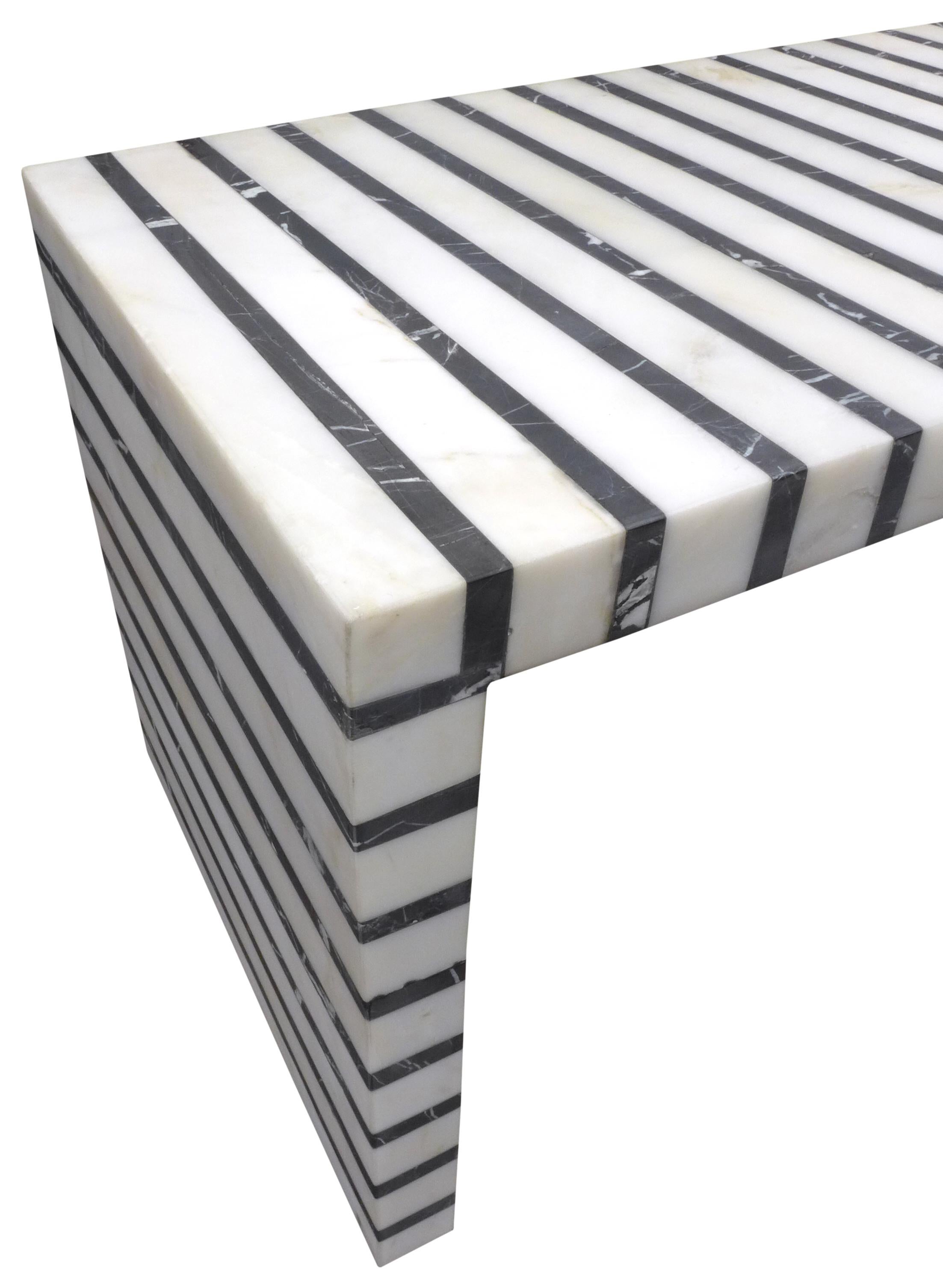 An outstanding black and white striped marble coffee table. A powerful, reduced, rectilinear form; a waterfall-style low table with single supporting beam in an unexpected material and appearance. Able to accommodate interiors of all stripes, a fun