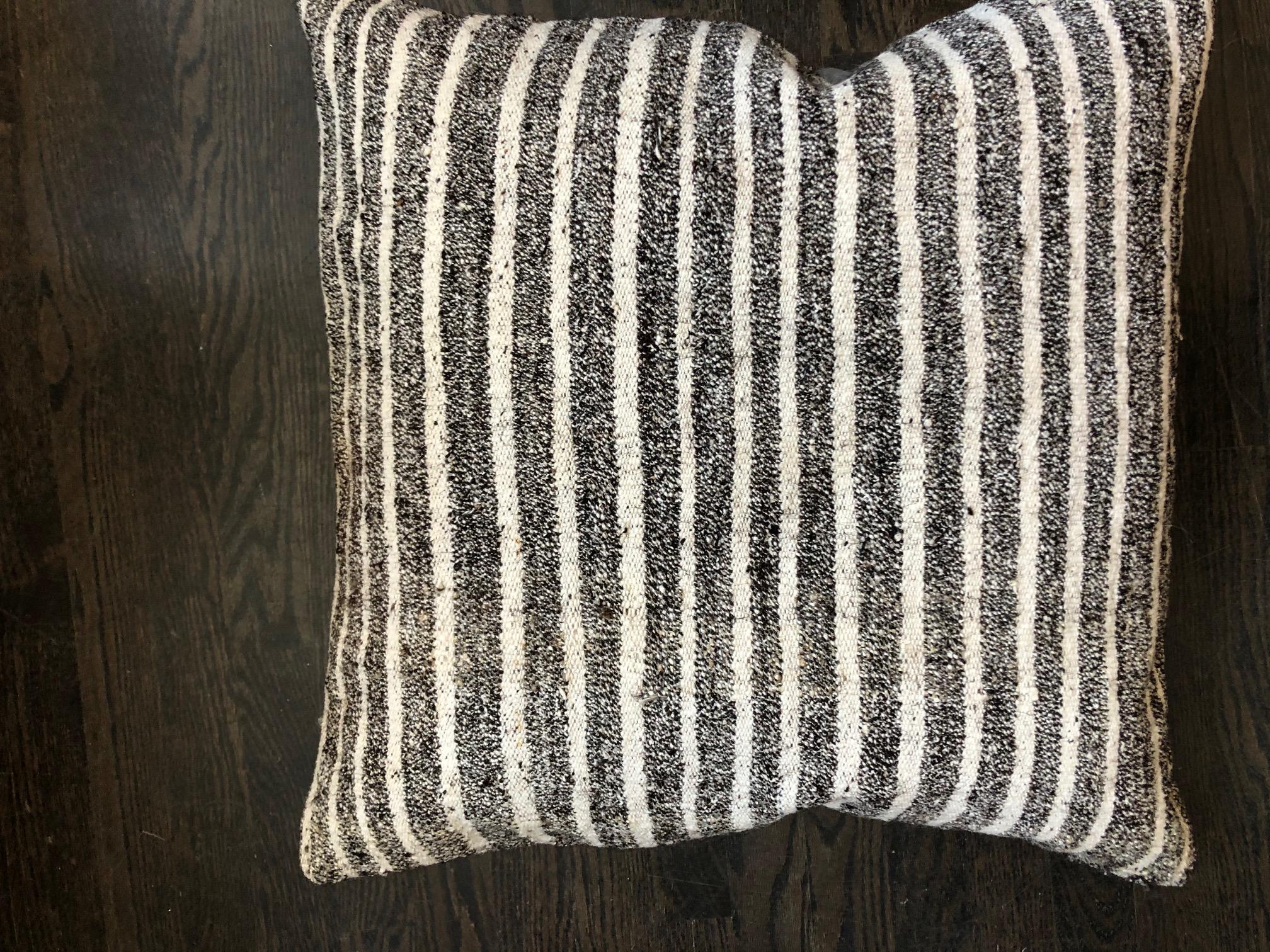 Black and white striped wool pillow by Le Lampade

Square striped hand knotted wool pillow.
Pillow insert is feather and has a concealed zipper. 100% natural fabric made in Italy.