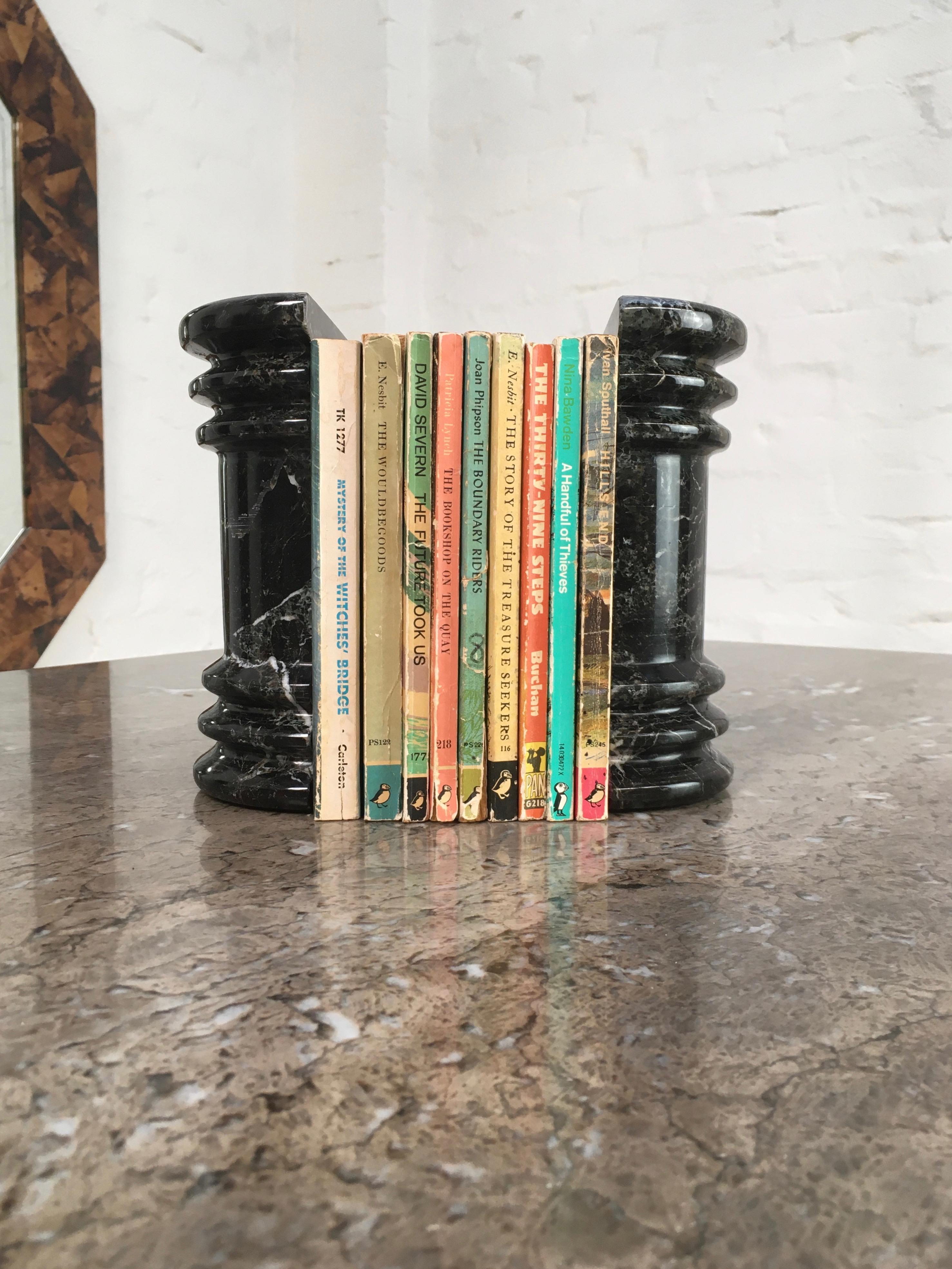A pair of substantial bookends with great decorative appeal. These column or pedestal bookends can hold up a good heft of books but are not too heavy to be easily handled and moved about to create the best decorative effect.

The black marble is