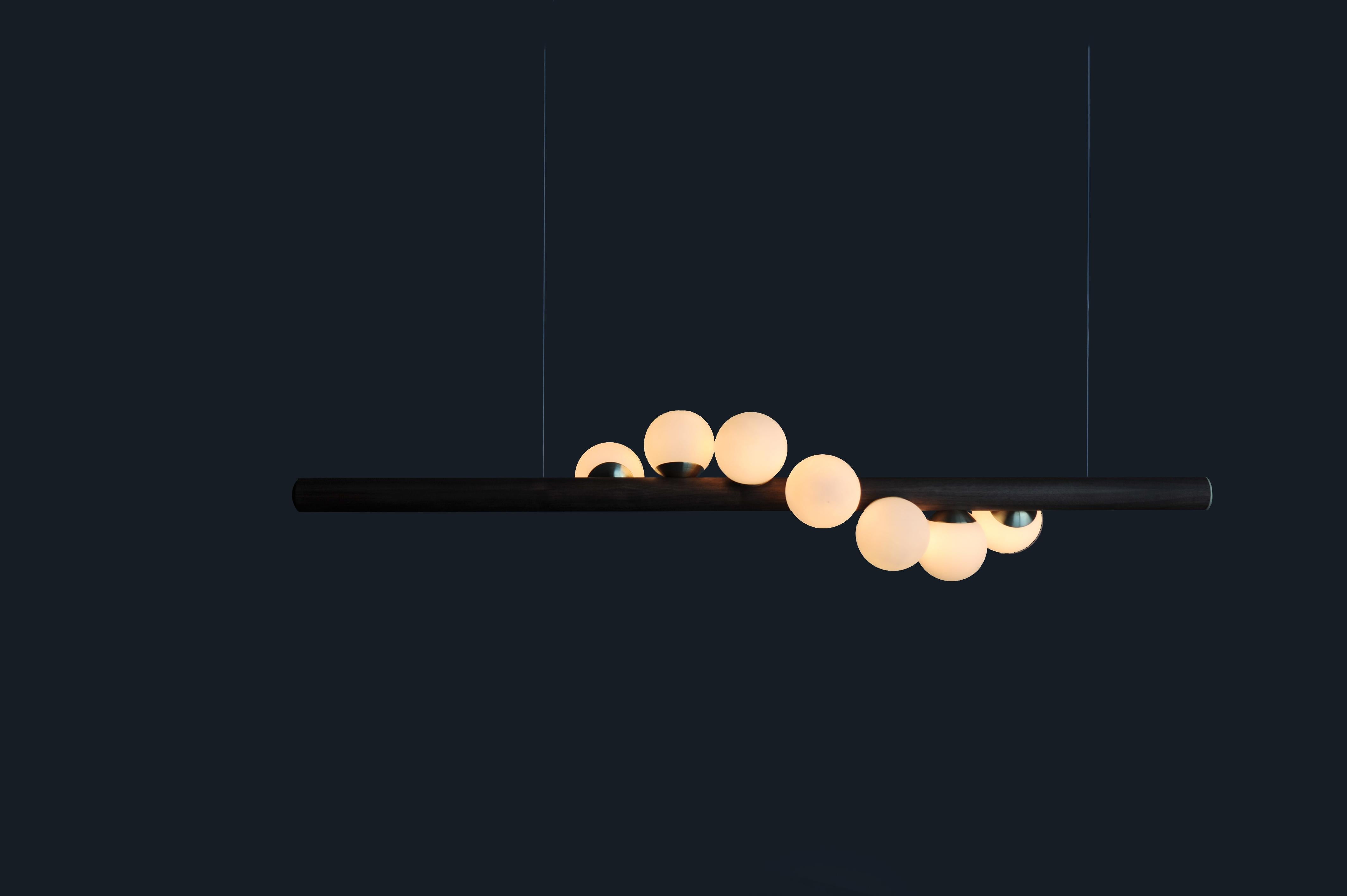 Black willow horizontal pendant light by Hollis & Morris
2019
Dimensions: 5ft - length 60” x diameter 2.25” 
Materials: Oak black, spun brass, hand blown glass

Options available:
Wood: W. oak white, w. oak natural, with oak black, walnut
3ft