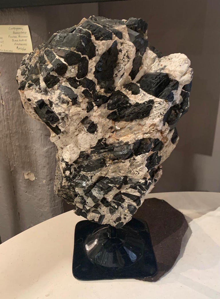 Brazilian large black cut tourmaline stone on stand.
Black mixed with cream.
Black Tourmaline is a stone often used for protection. 
It's a great stone for soaking up negative energies.
Stand measures 5