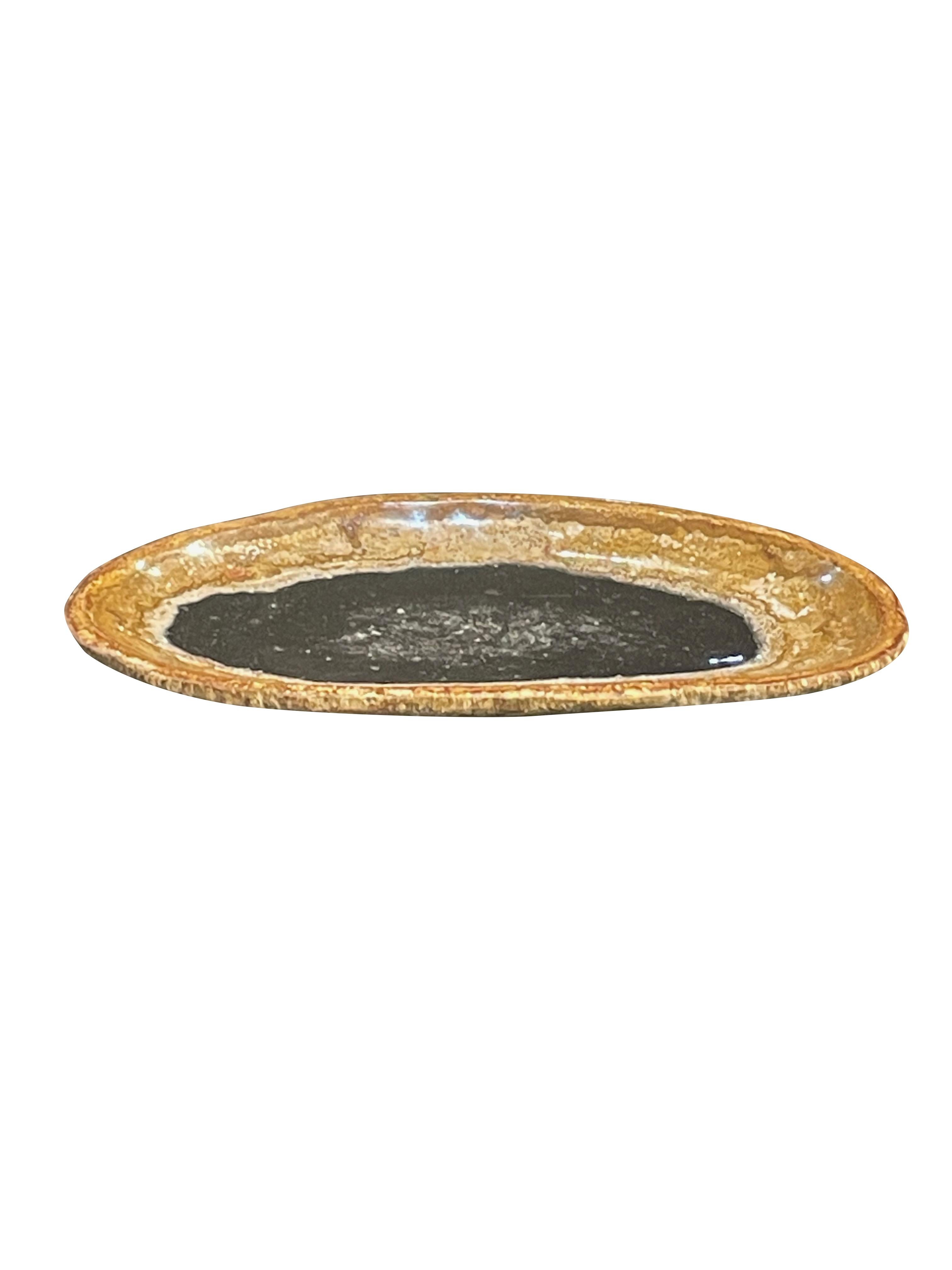 Indonesian large petrified wood platter.
Sliced from a petrified palm tree.
Black center with gold border.