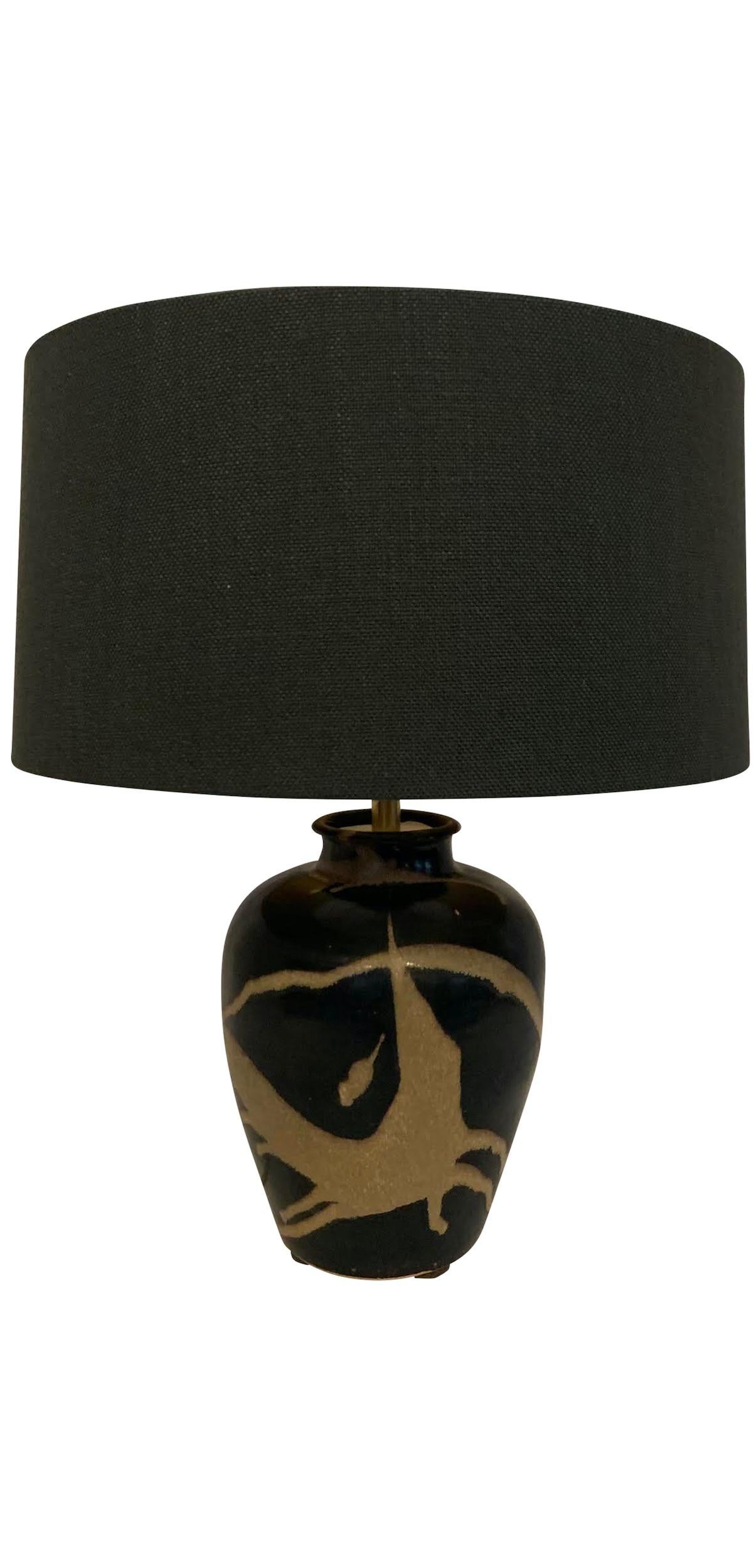 Contemporary Chinese pair of black ground lamps with abstract sand colored pattern design.
New black linen shades.
Base measures 7
