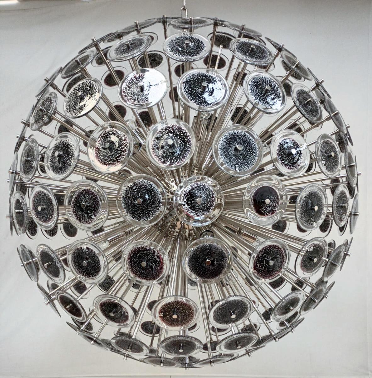 Italian round sputnik chandelier with black Murano glass discs infused with silver flecks, mounted on chrome plated metal frame by Fabio Ltd / Made in Italy
Measures: Diameter 43.5 inches, height 43.5 inches plus chain and canopy
16 lights / E26