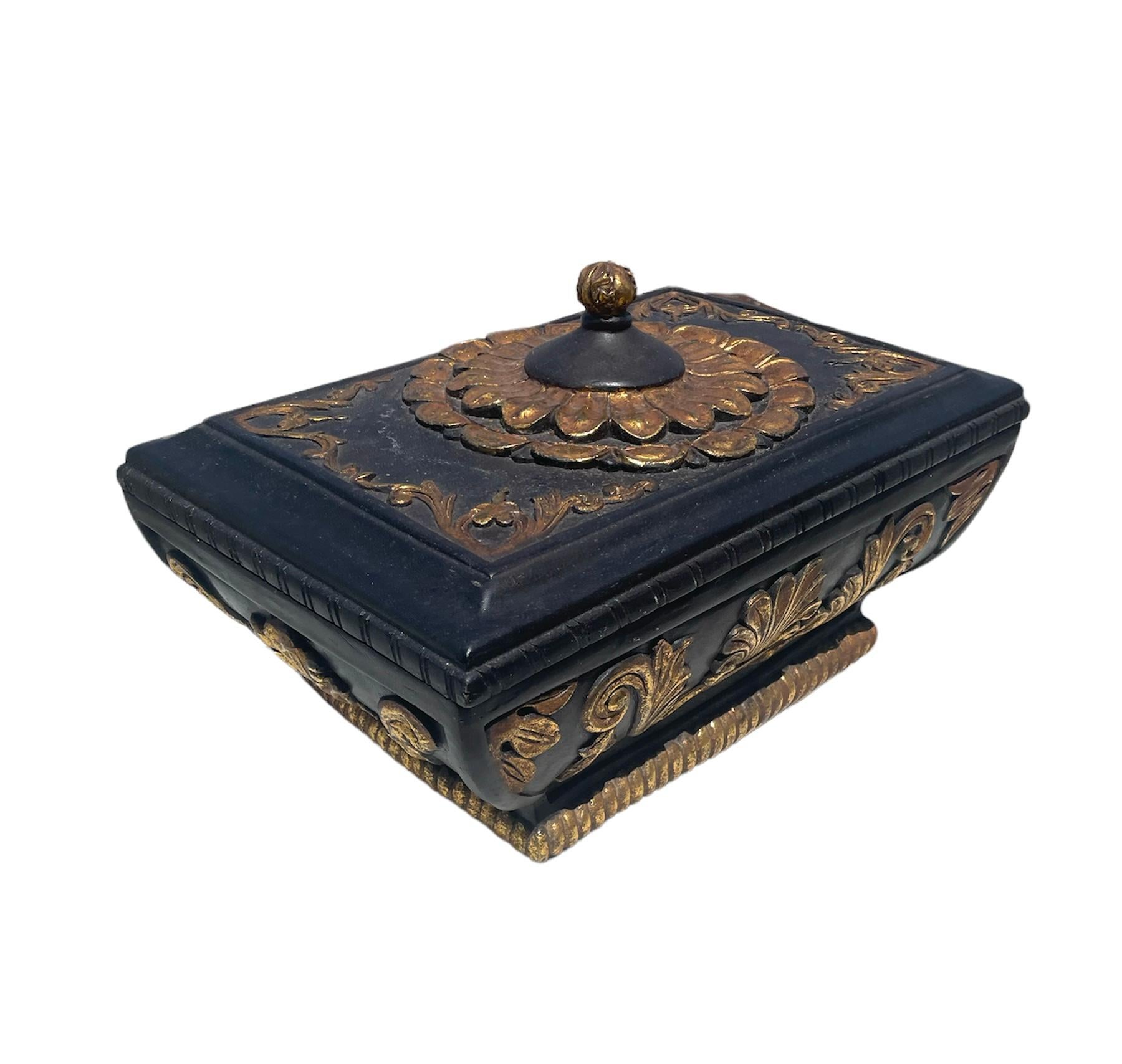 This is a very unique black wooden box with gold hand painted gilt.
The wood is thick in the structure is carved beautifully it’s feels like your holding a box for the crown jewels. Definitely a statement piece and can be used in Practical lifestyle