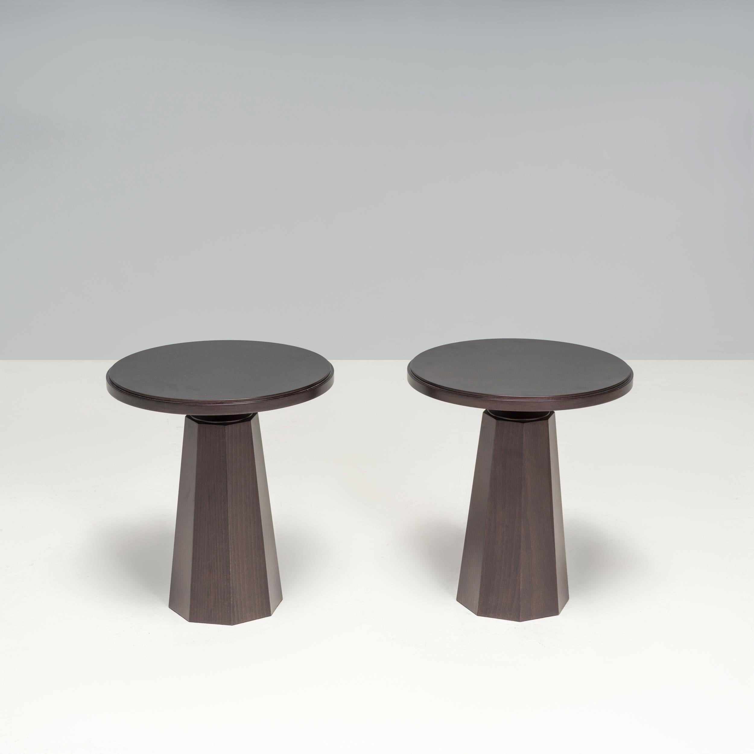  The side tables by Kelly Forslund are casually sophisticated with a modern aesthetic, these black pedestal round side tables are made from dark wood with a glossy sheen. The double set of grooves circling the table top's outer edge add definition