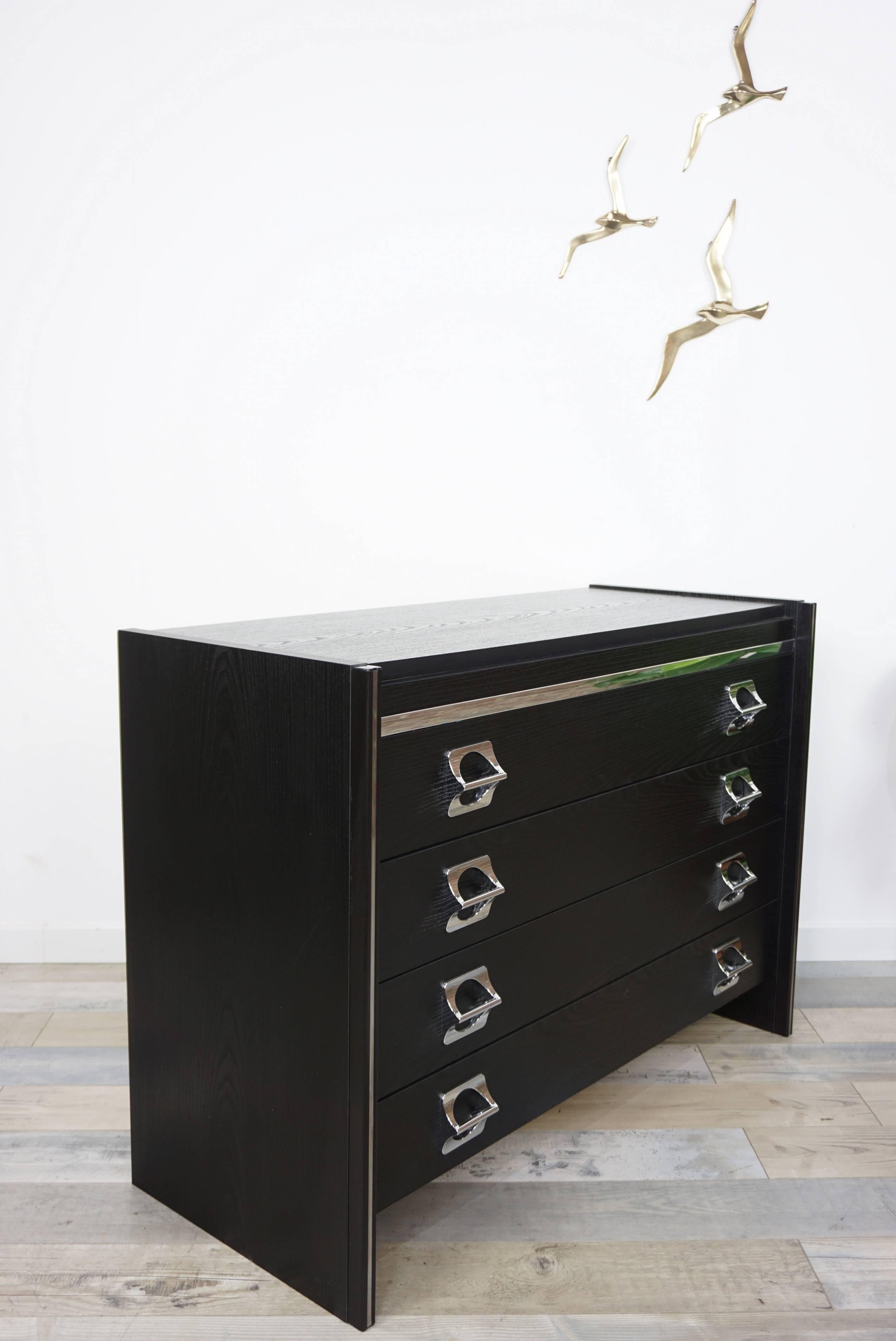 Black wooden and chromed resin handles vintage dresser with four large drawers.