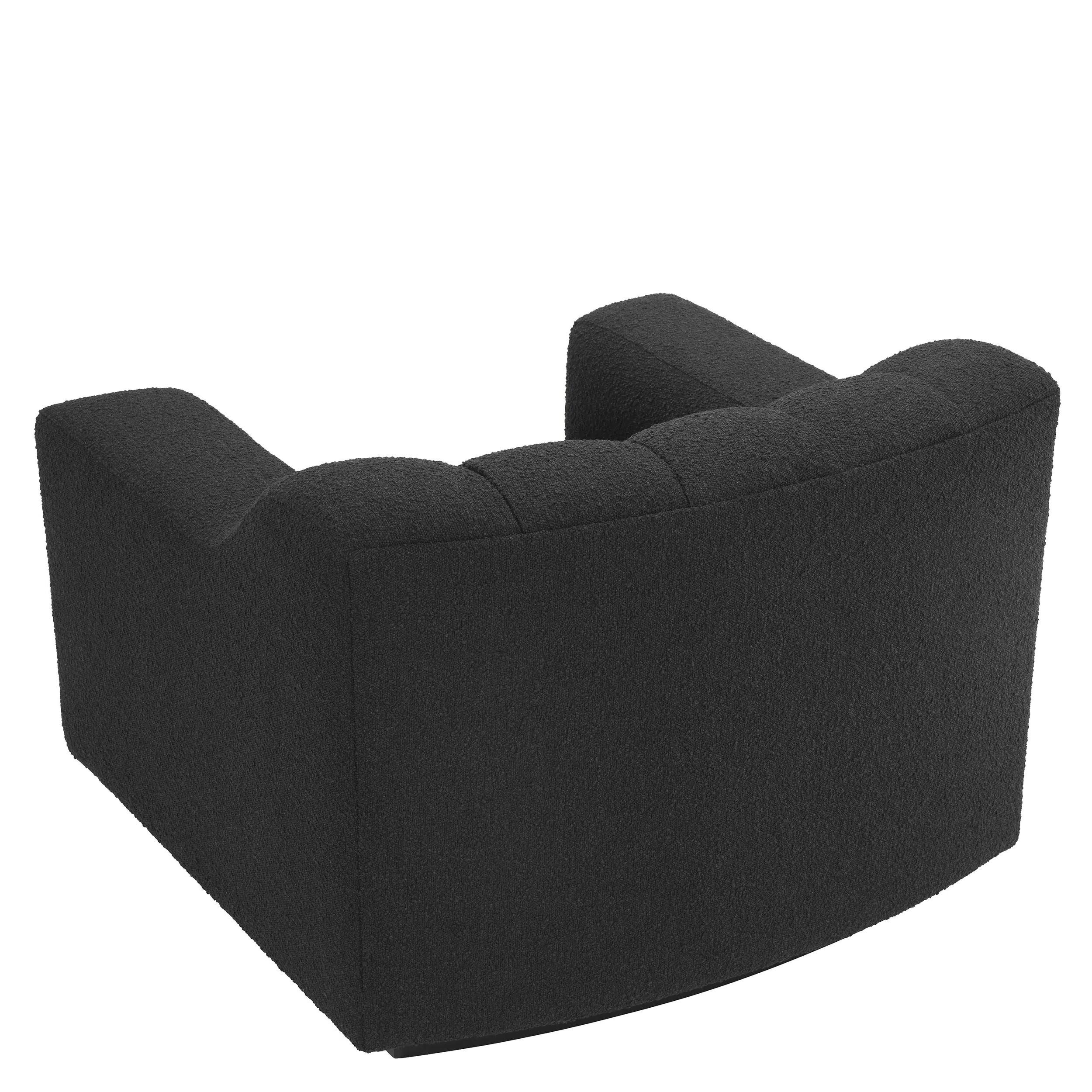 Vintage design style black wooden feet and black bouclé fabric slightly curved and padded armchair.