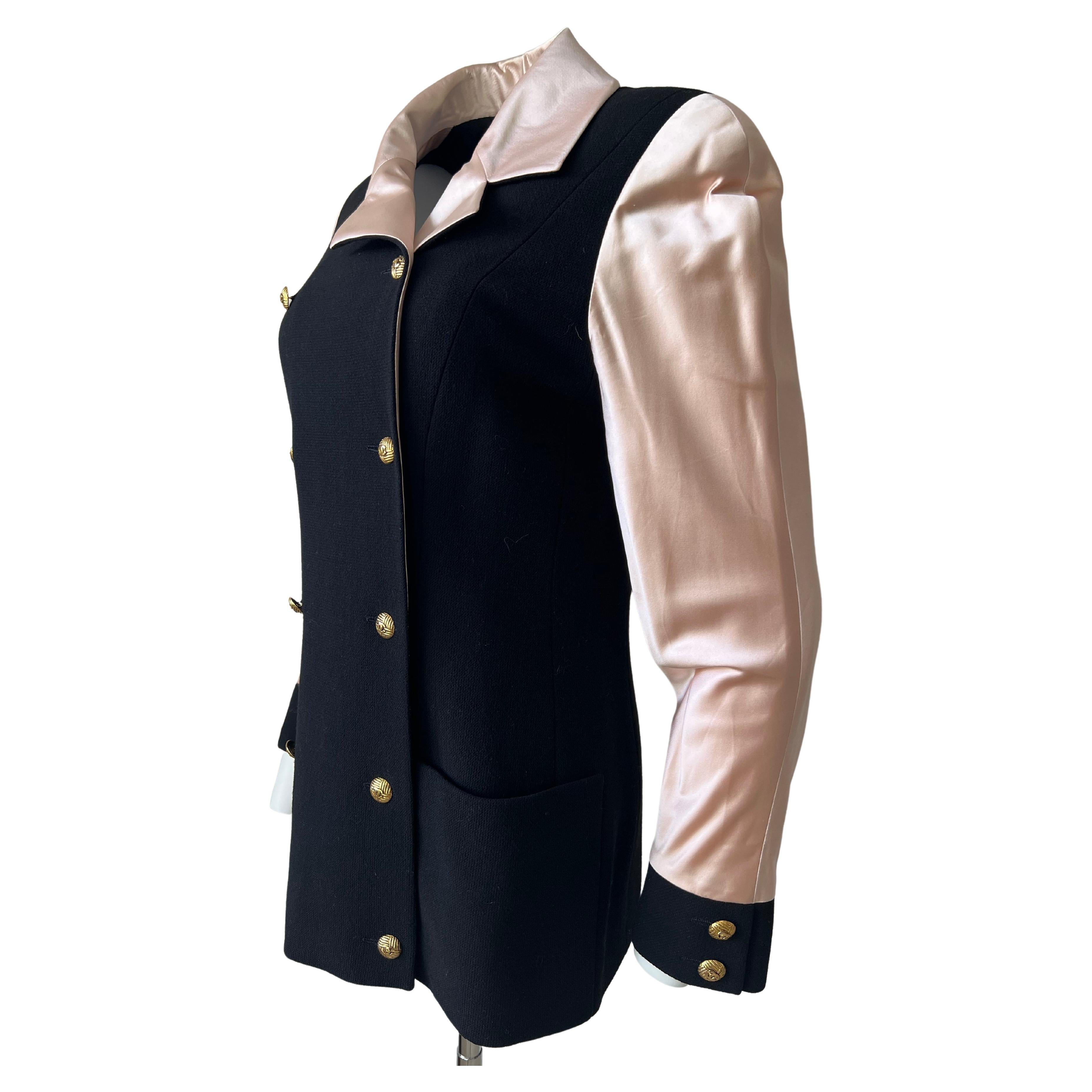 Superb Chanel jacket from the 23 collection of the year 1984, a year after Karl Lagerfeld is named Artistic Director of CHANEL. Black wool jacket, sleeve and collar in powder pink silk is the iconic and identical color of the chanel house. Ten gold