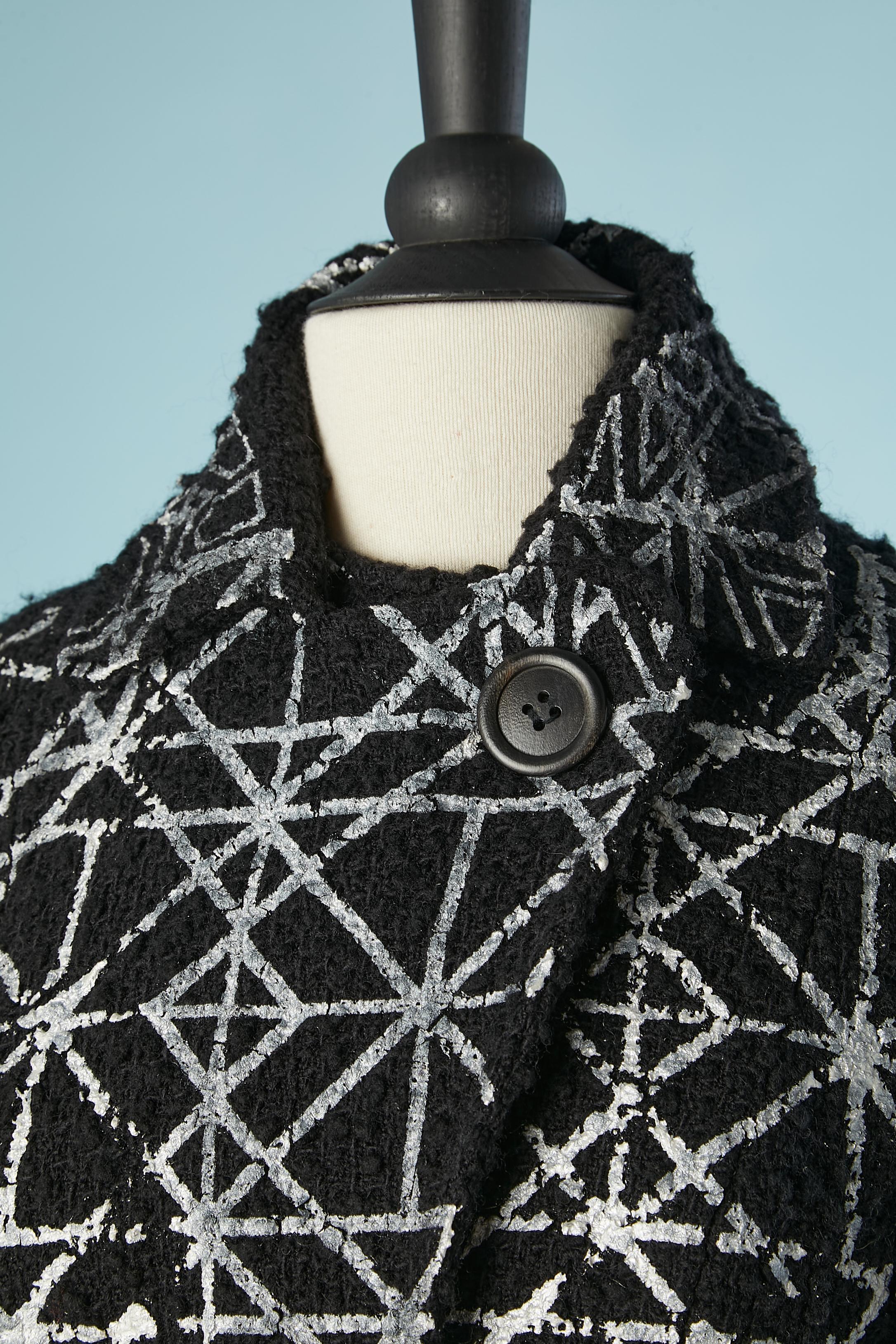 Black wool bouclette jacket with silver paint appliqué pattern. No fabric composition tag. White lining probably polyester. Half-belt in the front. 