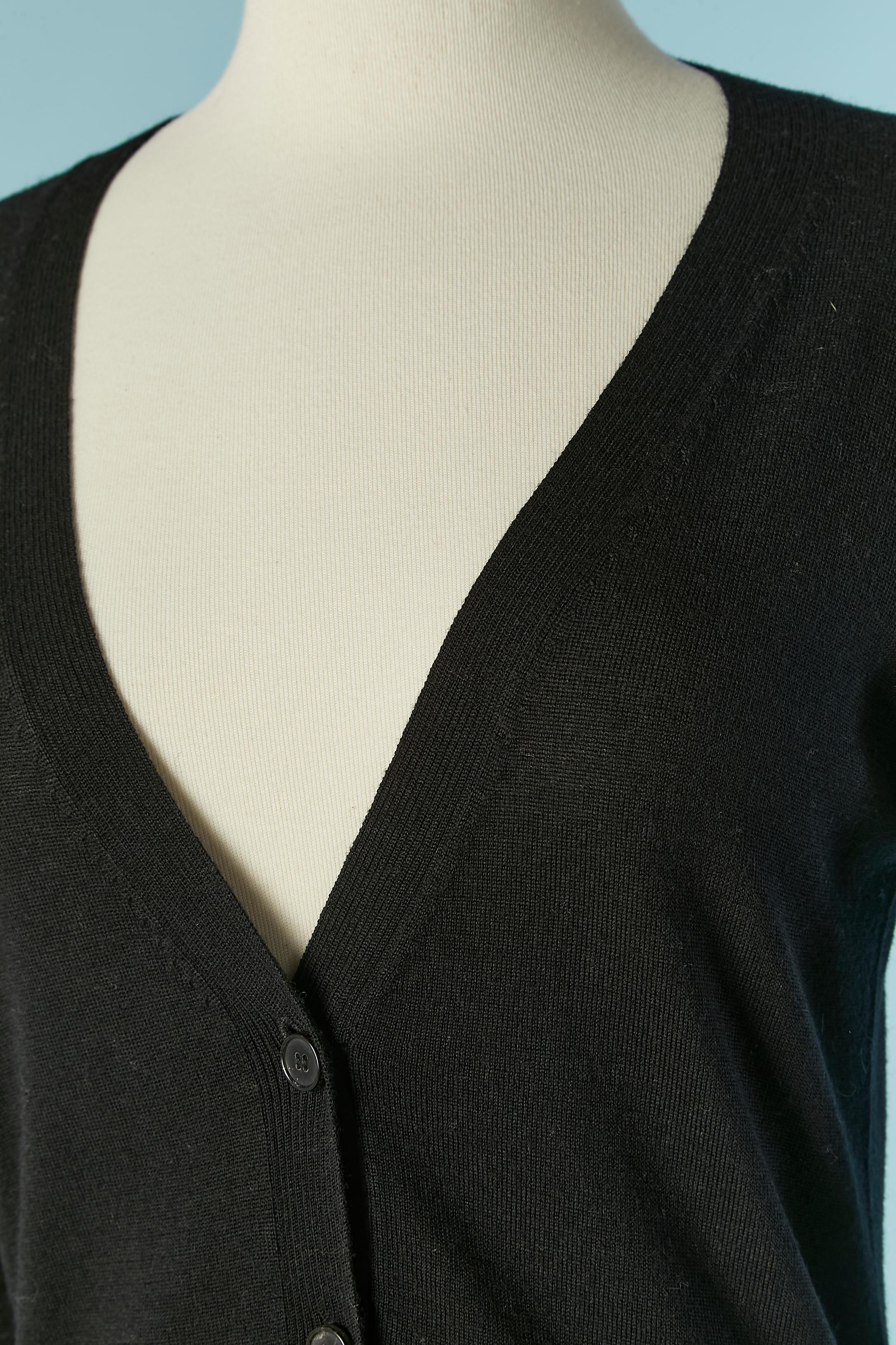 Black wool cardigan . Button and buttonhole closure on the middle front. Pocket on both side. Cut-work on the elbow 
SIZE S 
