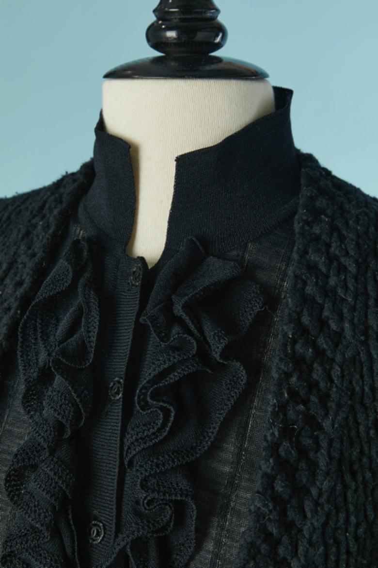 Black wool cardigan with black rayon ruffles on the front with button and buttonhole closure on the front. The ruffles are not detachable.
SIZE 36( Fr) on tag but fit M 