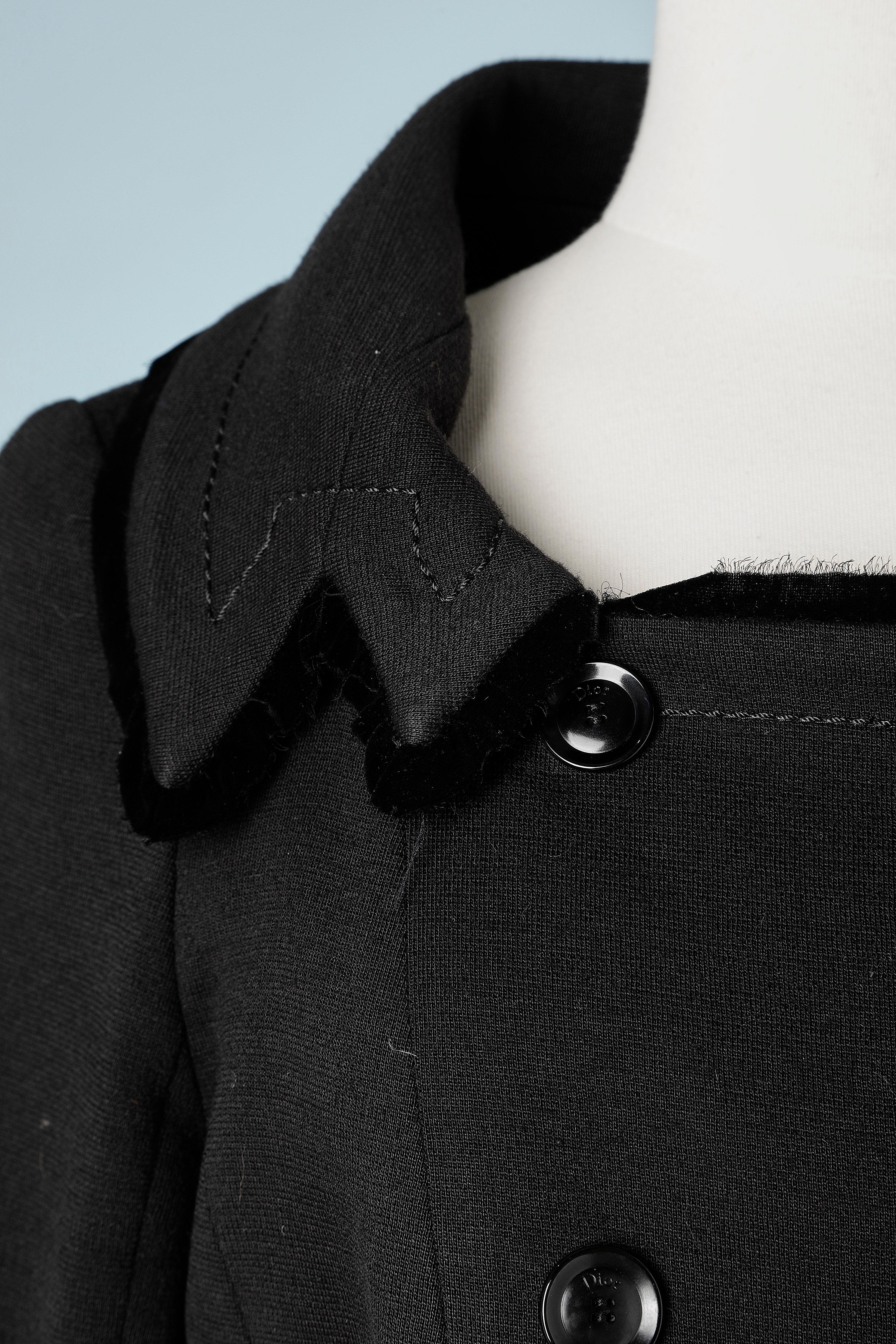 Black wool double-breasted jacket with black velvet edge raw cut. 
Branded buttons. 
Fabric composition: 50% wool, 50% acrilyc.
Silk lining.
SIZE 42 (Fr) 12 (US) 