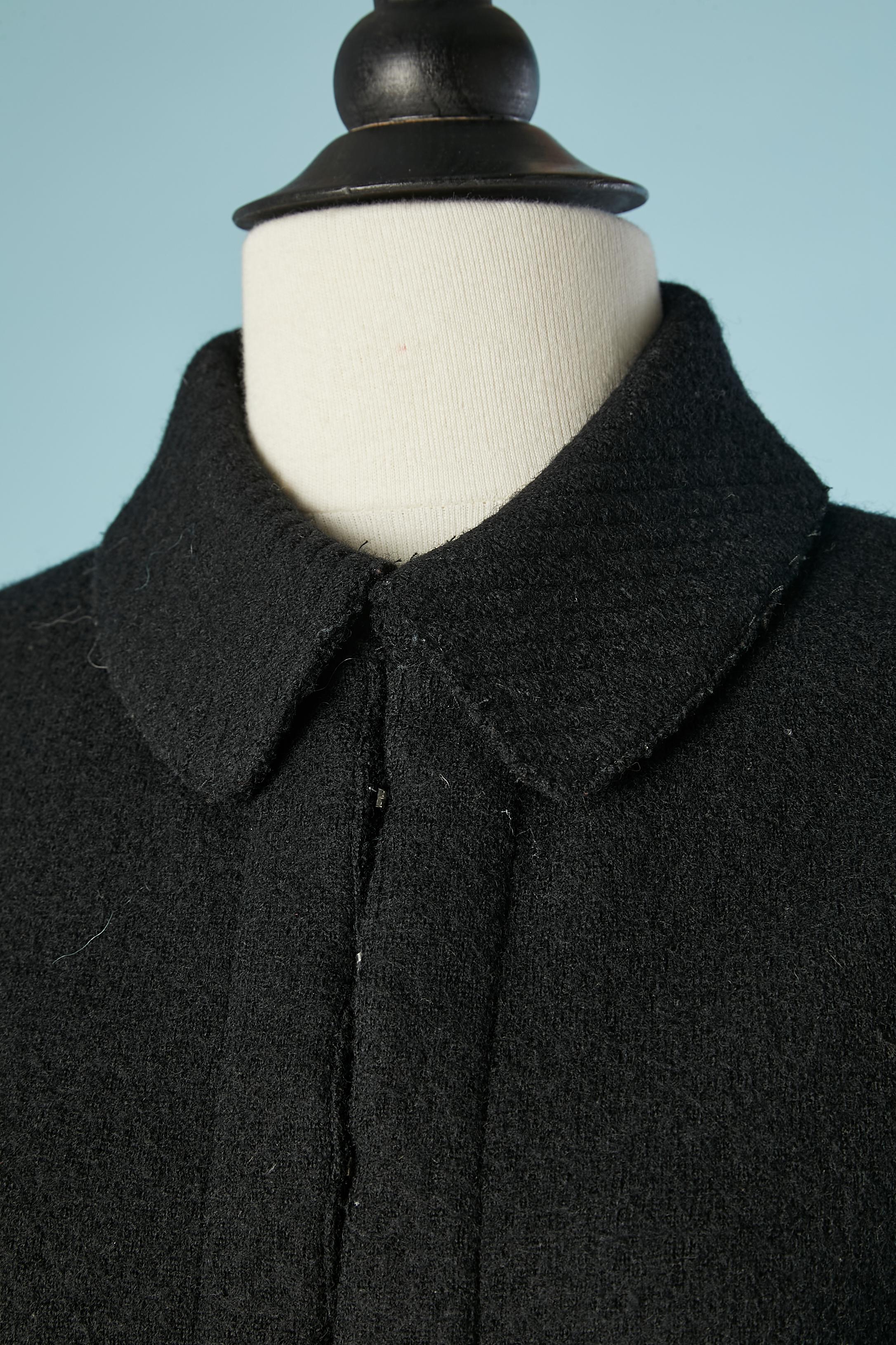 Black wool knit skirt-suit with edge to edge jacket and top-stitched collar and pocket-flap. 
SIZE 38 (M) 
