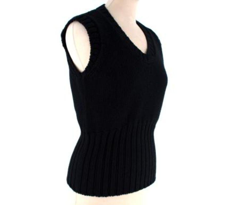 Tom Ford Black Knitted Vest
 

 - Black chunky knit v-neck vest 
 - Large ribbed waistband 
 - Sleeveless  
 

 Materials 
 100% Wool 
 

 Made in Italy 
 

 PLEASE NOTE, THESE ITEMS ARE PRE-OWNED AND MAY SHOW SIGNS OF BEING STORED EVEN WHEN UNWORN