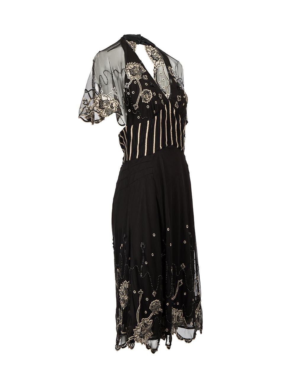 CONDITION is Very good. Hardly any visible wear to dress is evident on this used Temperley London designer resale item. 



Details


Black

Polyester

Knee length dress

Floral beaded embellishment accent

Halter V neckline

Sheer sleeves