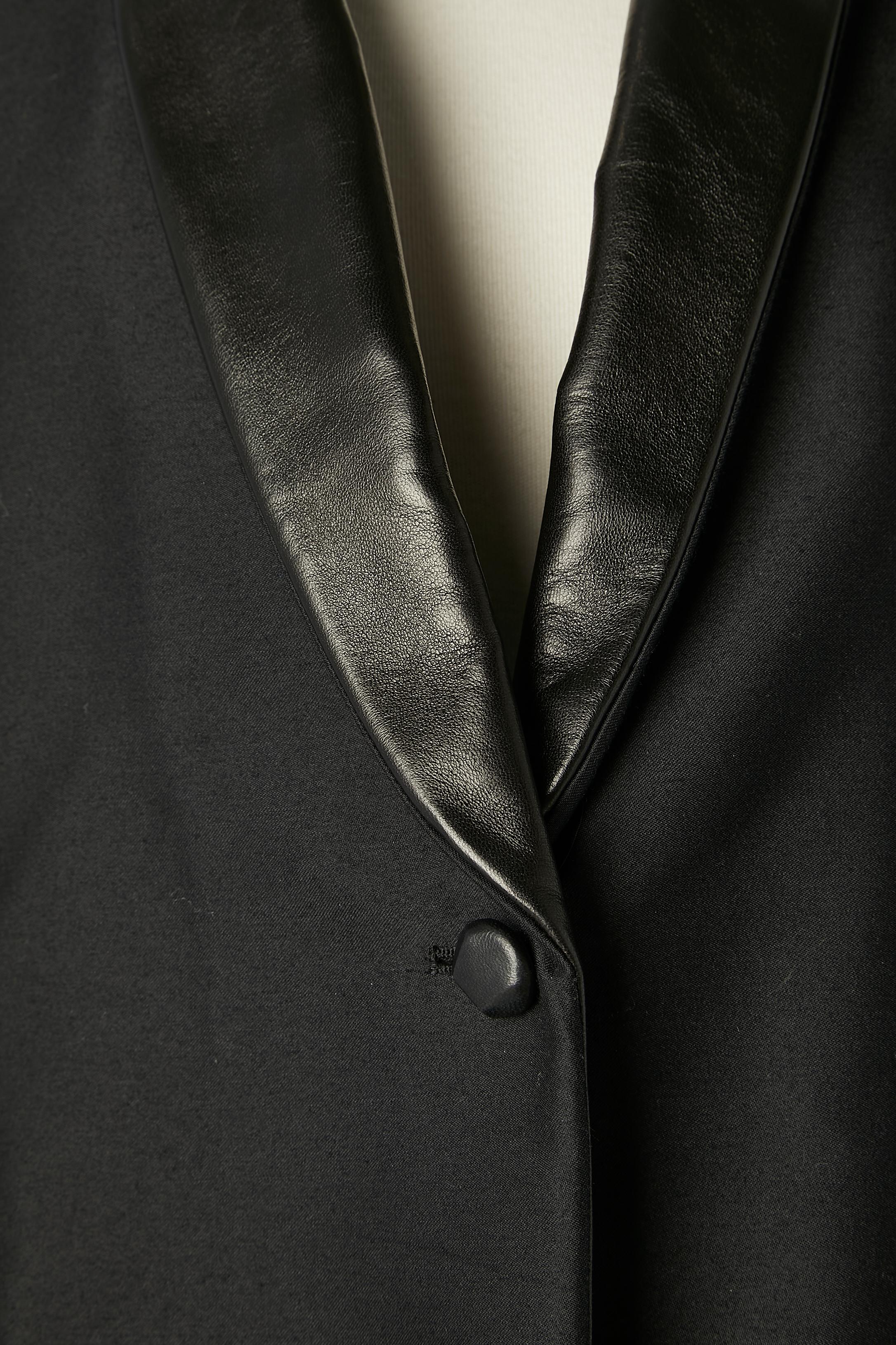 Black wool single-breasted tuxedo with black leather collar. Split in the middle back = 19 cm. Leather button.
Fabric composition: 79% wool, 21 % silk . Leather (agnello lamb)
Silk lining. F/W 2012
SIZE 38 (M)
