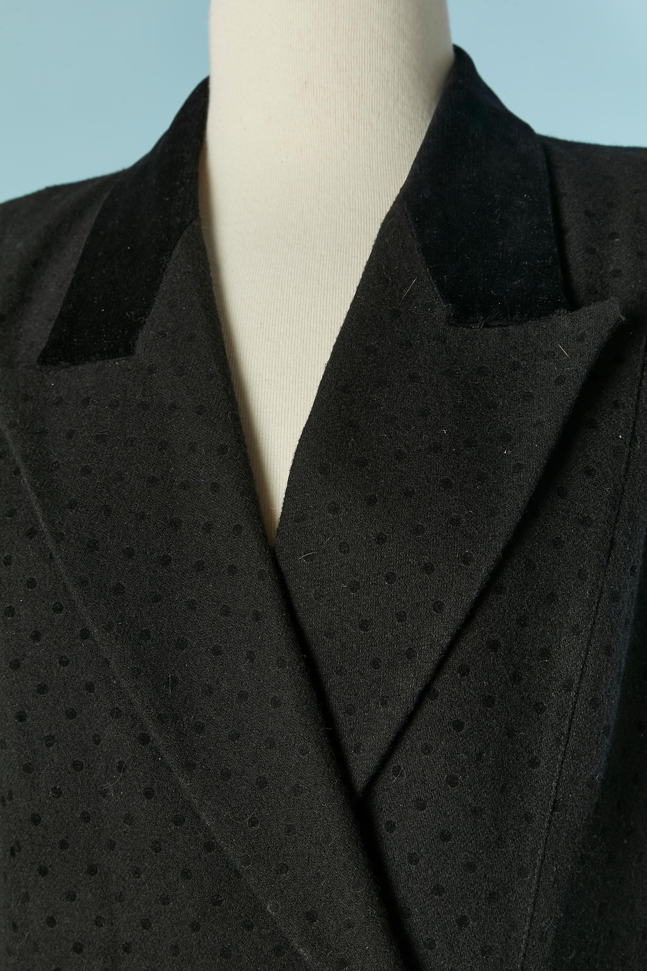 Black wool skirt suit with polka dots pattern and velvet collar and cuffs. 
Main fabric composition: 60% wool, 30% polyester, 5% rayon, 5% other fiber. Lining composition: 100% acetate
Shoulder pad. Double lay of fabric on the hips ( on the