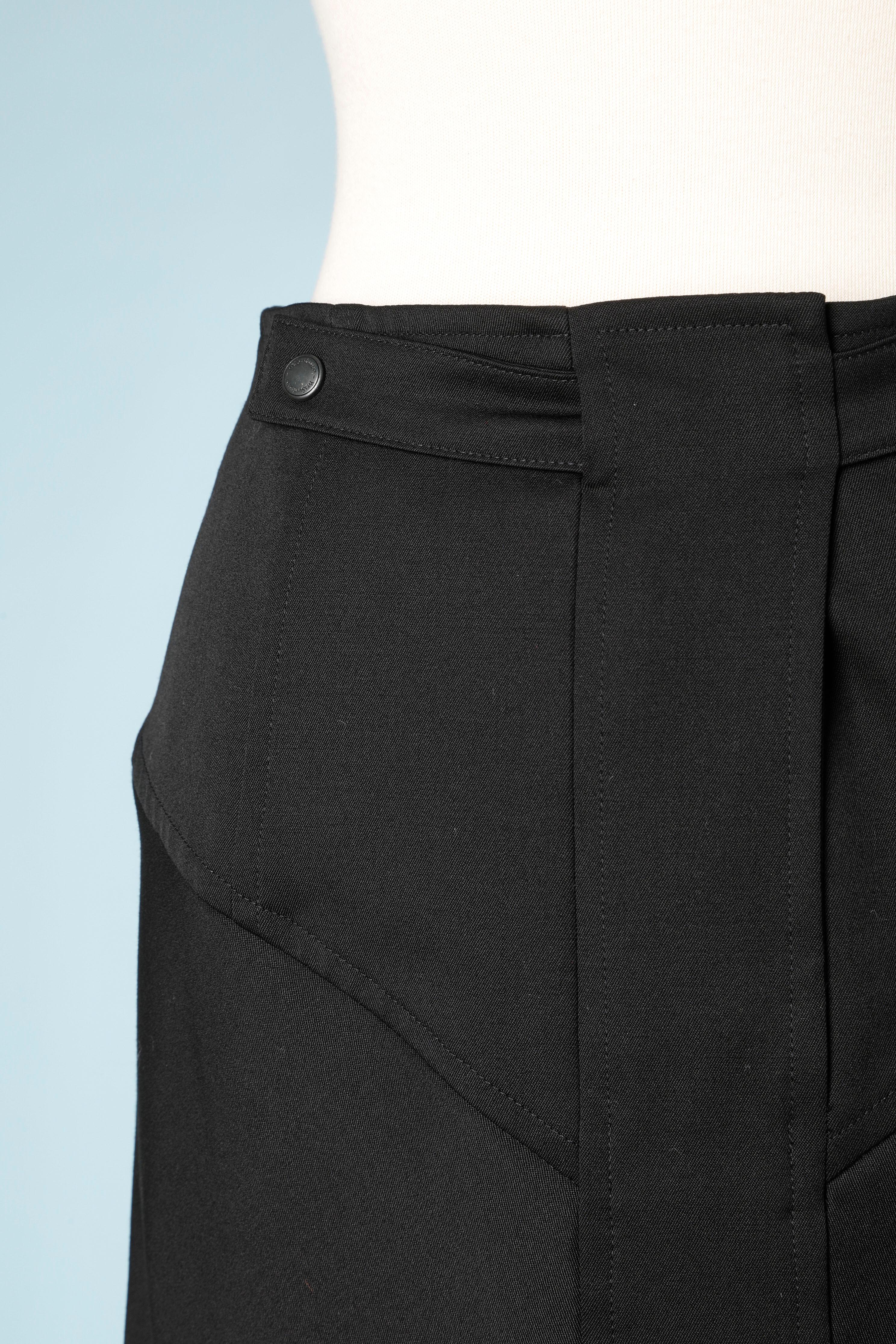Black wool skirt with branded snap and zip in the middle front closure. 
Fabric composition: 98% wool, 2% stretch 
No lining, cut-work. 
SIZE 36 (Fr) 6 (Us) S 