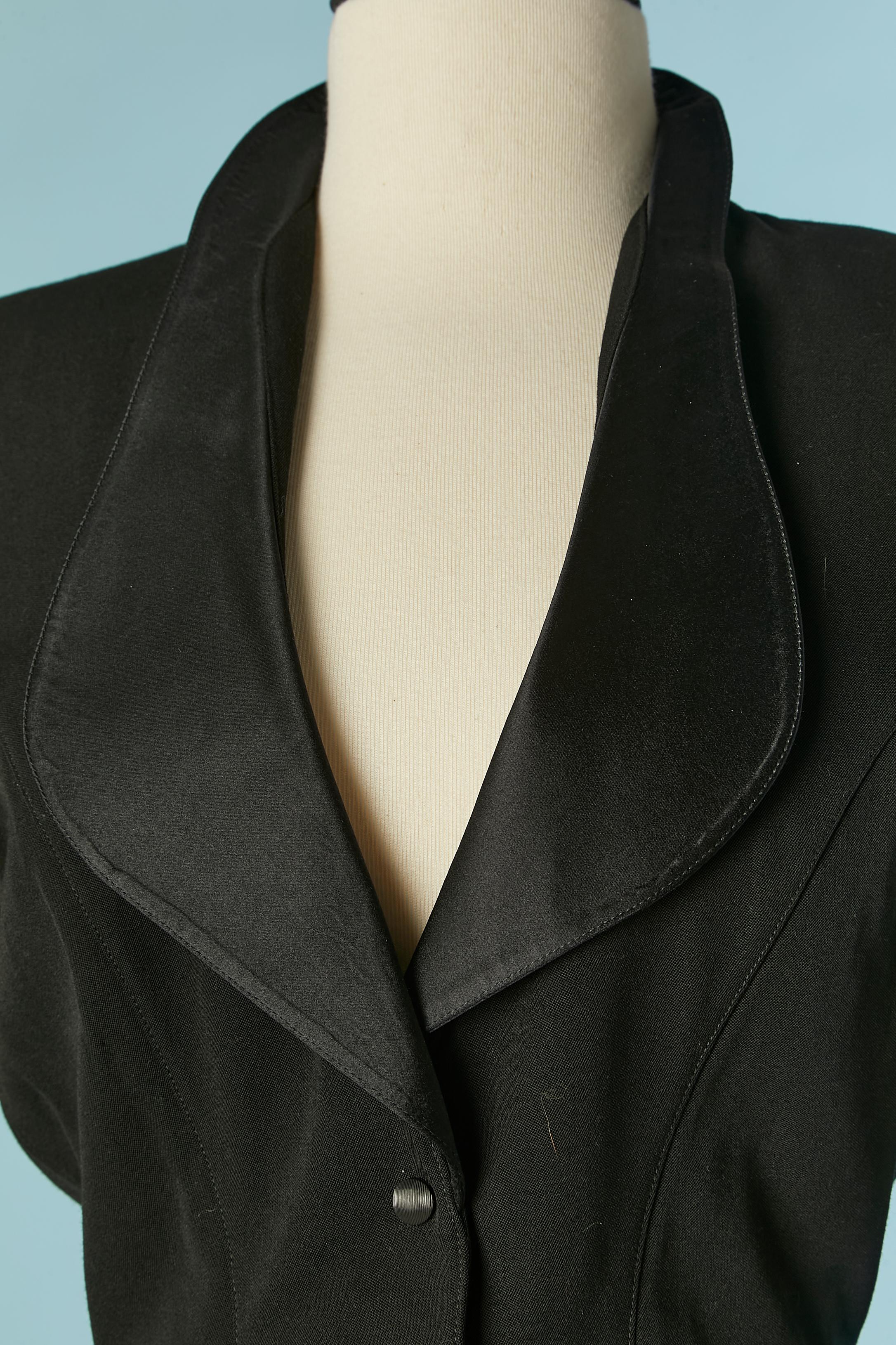 Black wool Tuxedo trouser-suit with silk satin collar. Rayon lining. 
Shoulder-pad. Cut-work. Snap closure in the middle front. 
SIZE of the jacket : 38 (Fr) on tag but fit S 
SIZE of the trouser : 38 (Fr) on tag but fit XS 