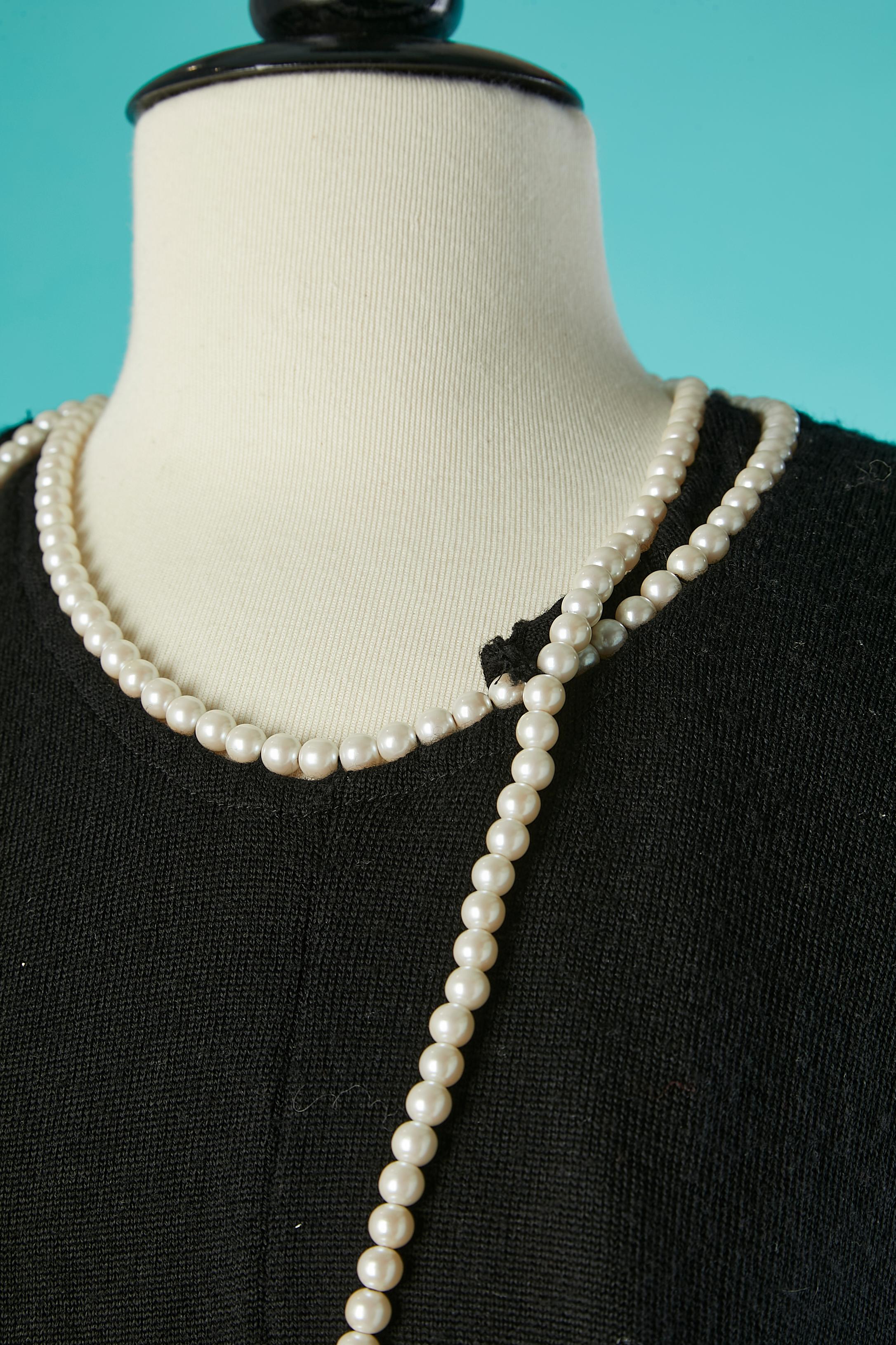 Black wool wrap sweater with pearls neckless.
Clasp on the neckless in the middle front 
SIZE M