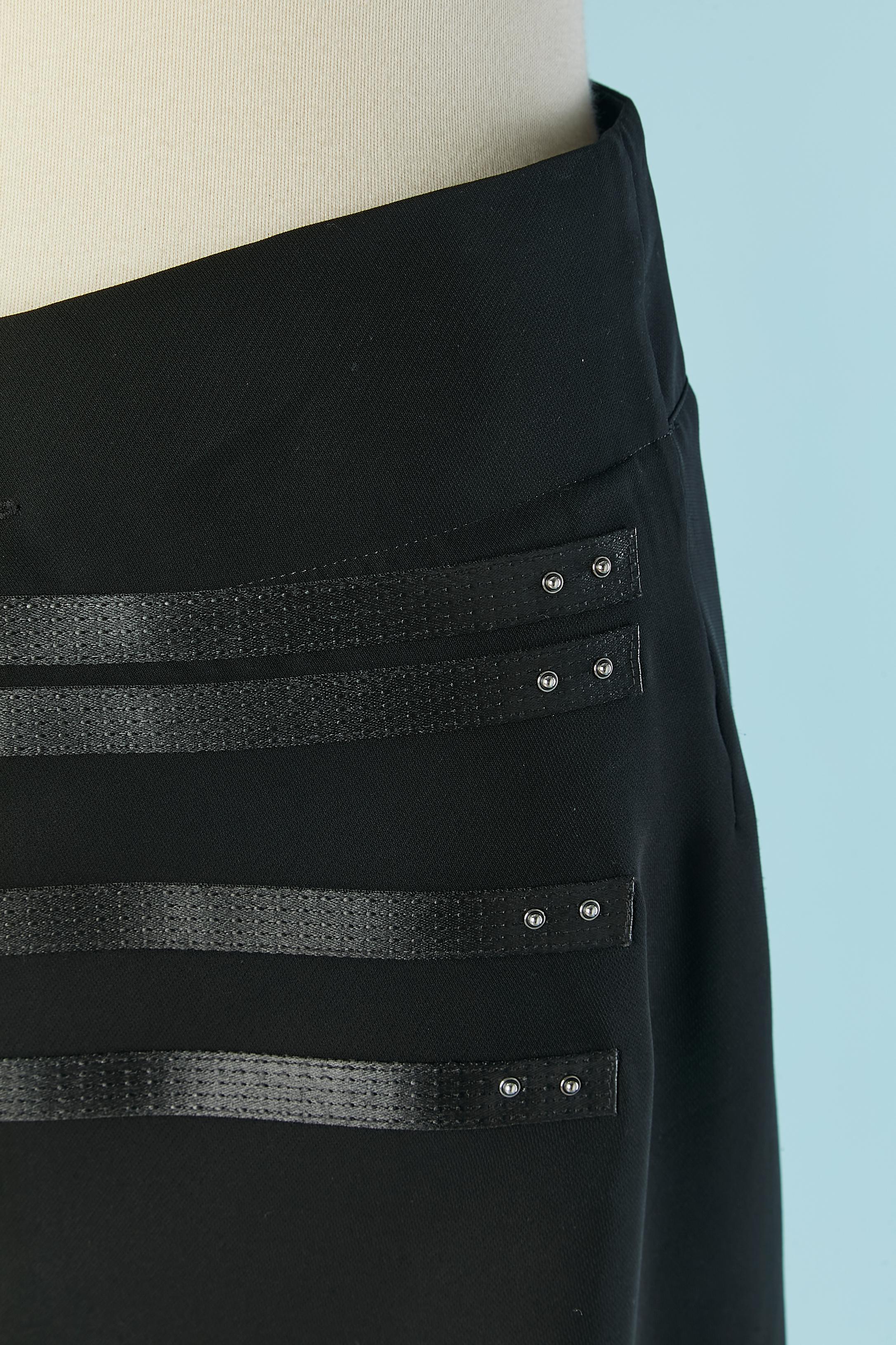Black wrapped skirt with top stitching satin strap and silver metal stud. Shell fabric composition: 100% polyester. Lining: 100% cupro. 
SIZE M 