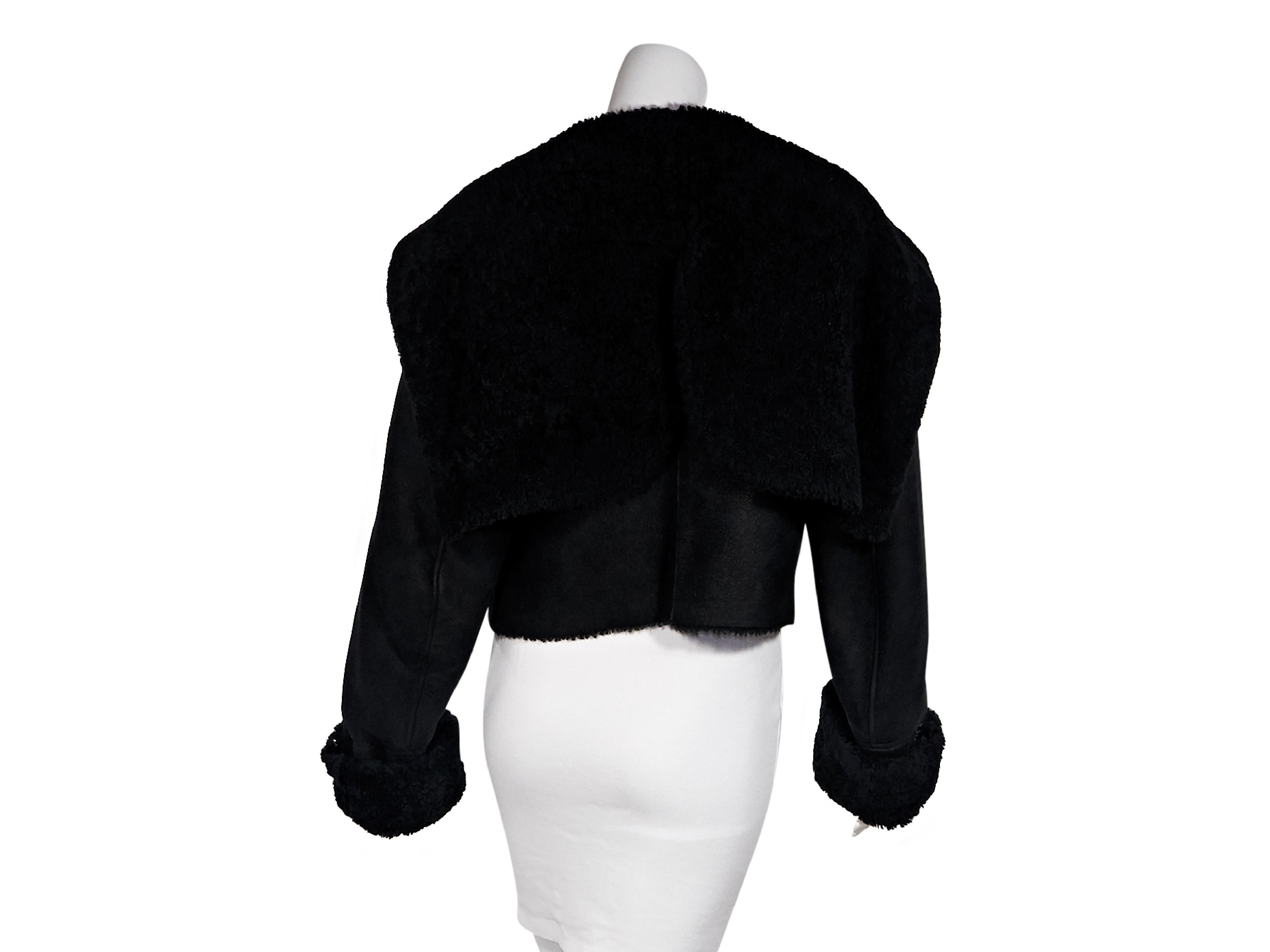 Product details:  Black shearling cropped jacket by Yeezy.  Exaggerated collar.  Long sleeves.  Asymmetrical zip-front closure.  Waist zip pockets.  Black hardware.  37