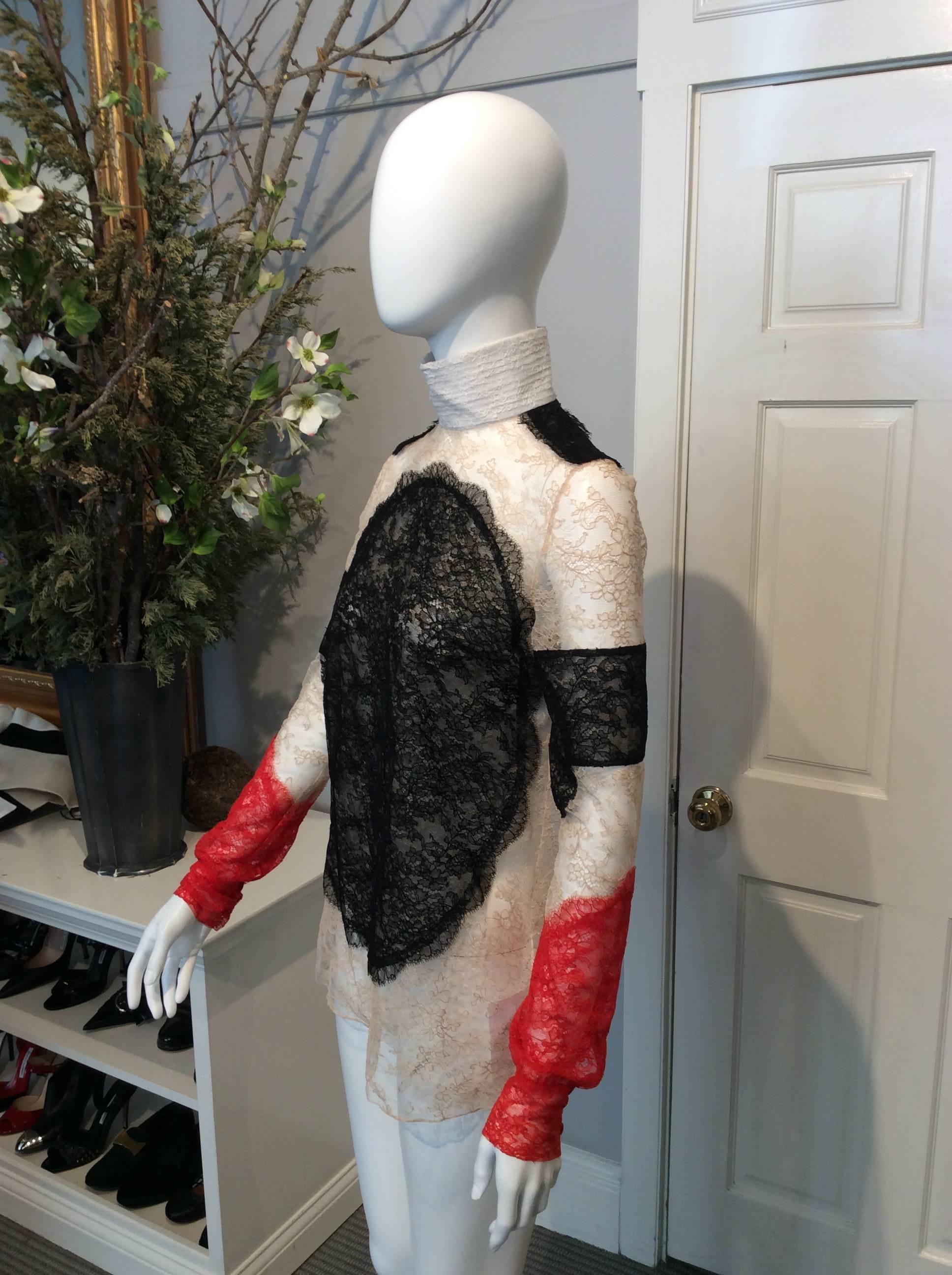 Black, red, nude lace Givenchy semi-sheer long-sleeve top with ivory high-collar. Zipper with hook and eye closure at back of neck. Three red fabric covered buttons located on cuff. 

Sizing: Fr36, Us4

Fabric content: 70% nylon, 30% viscose 
