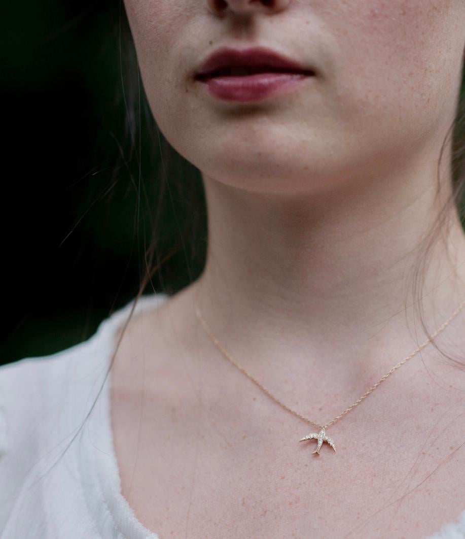 Our 'Fancy Bird' Necklace is a Blackbird and the Snow Favorite. Cast in 14k yellow gold, finished with fine milgrain detailing and set with eleven brilliant cut diamonds. This whimsical bird hangs on a delicate 16-18