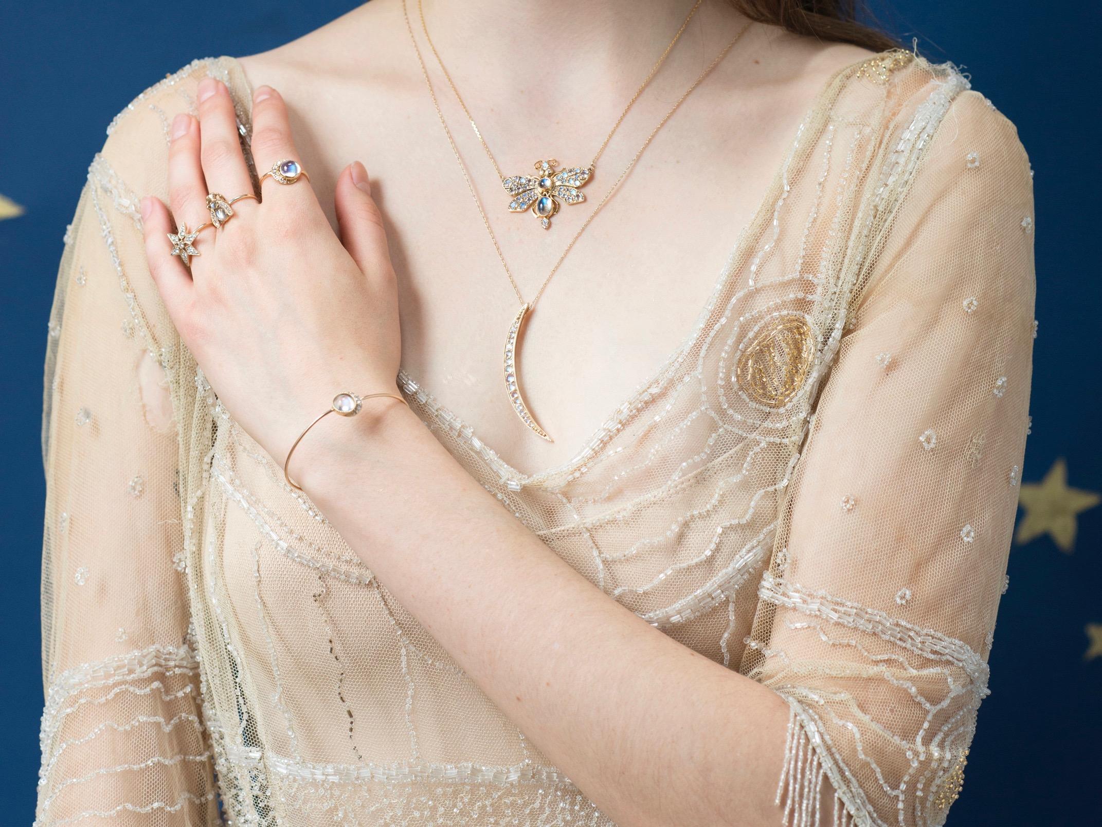 Our 'Moon Slice' Necklace is a poetic wonder. Cast in 14k yellow gold and set with rare, rose cut moonstones. The crescent charm hangs on an 18-20