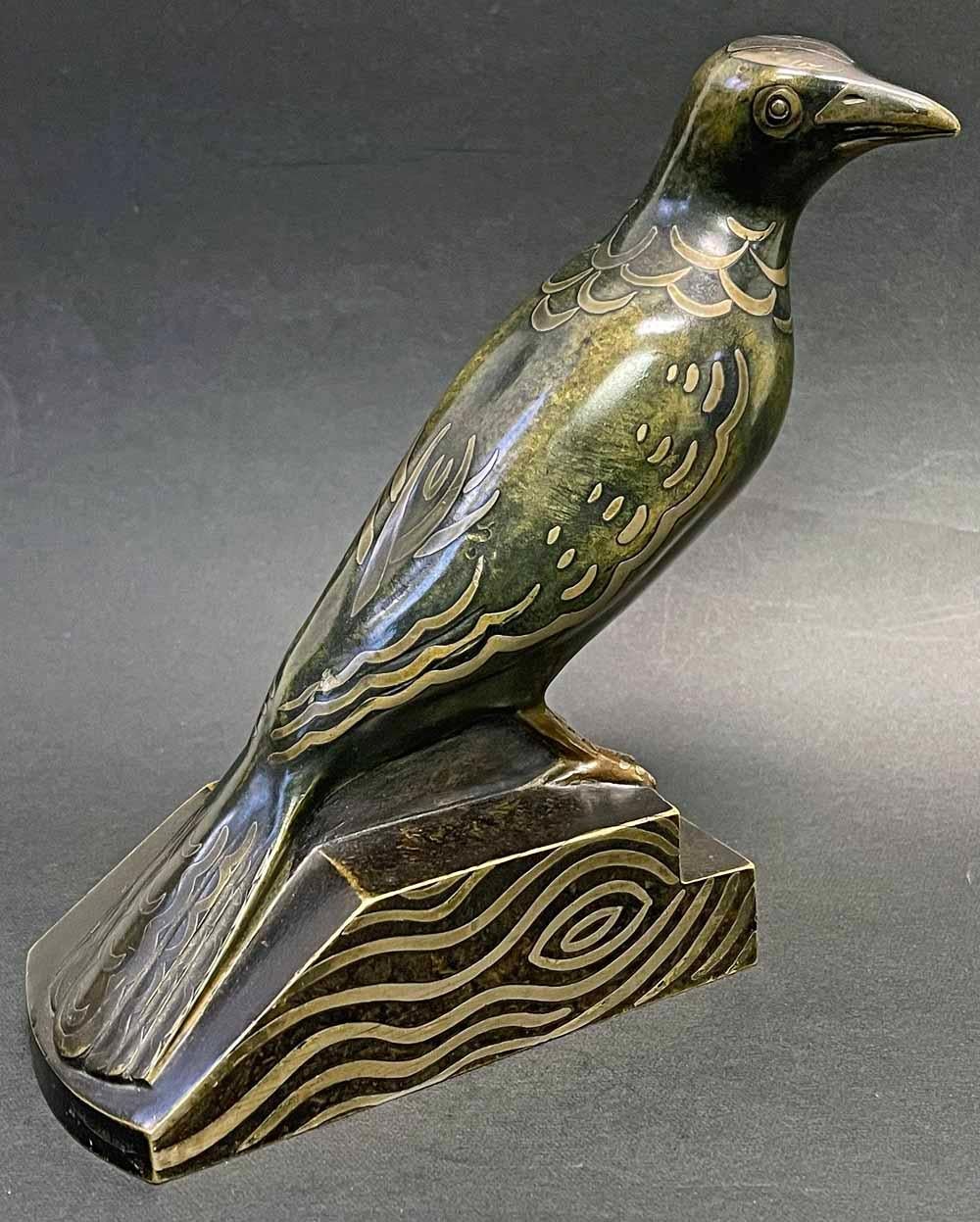 Elegant and sophisticated, this bronze blackbird -- inset with a second metal, probably silver -- was designed by Jean Luce, one of France's master designers in the Art Deco period.  Mixed metal (or dinanderie) artisanry was revived by a number of