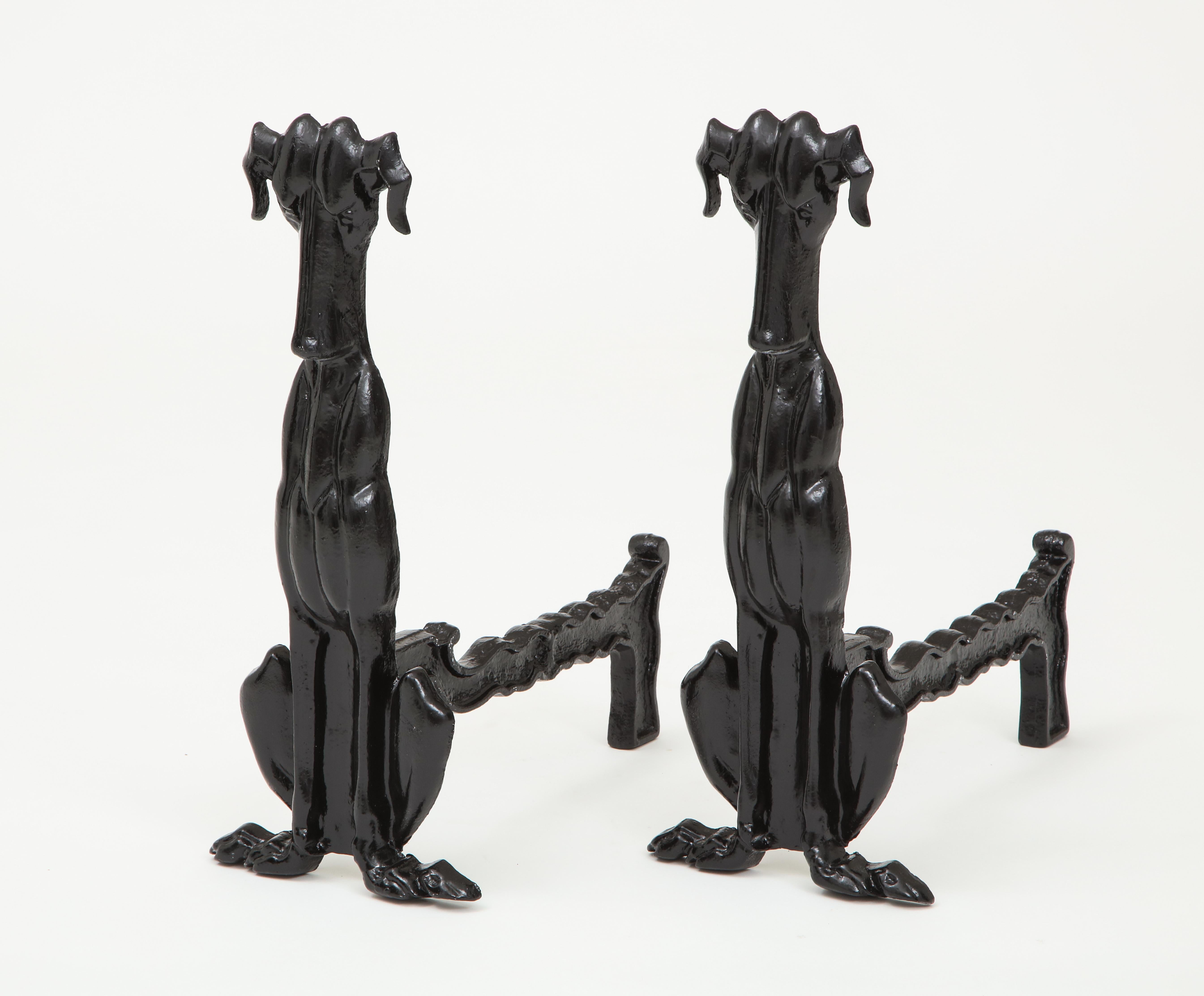 Pair of stylized standing whippet andirons in blackened bronze.