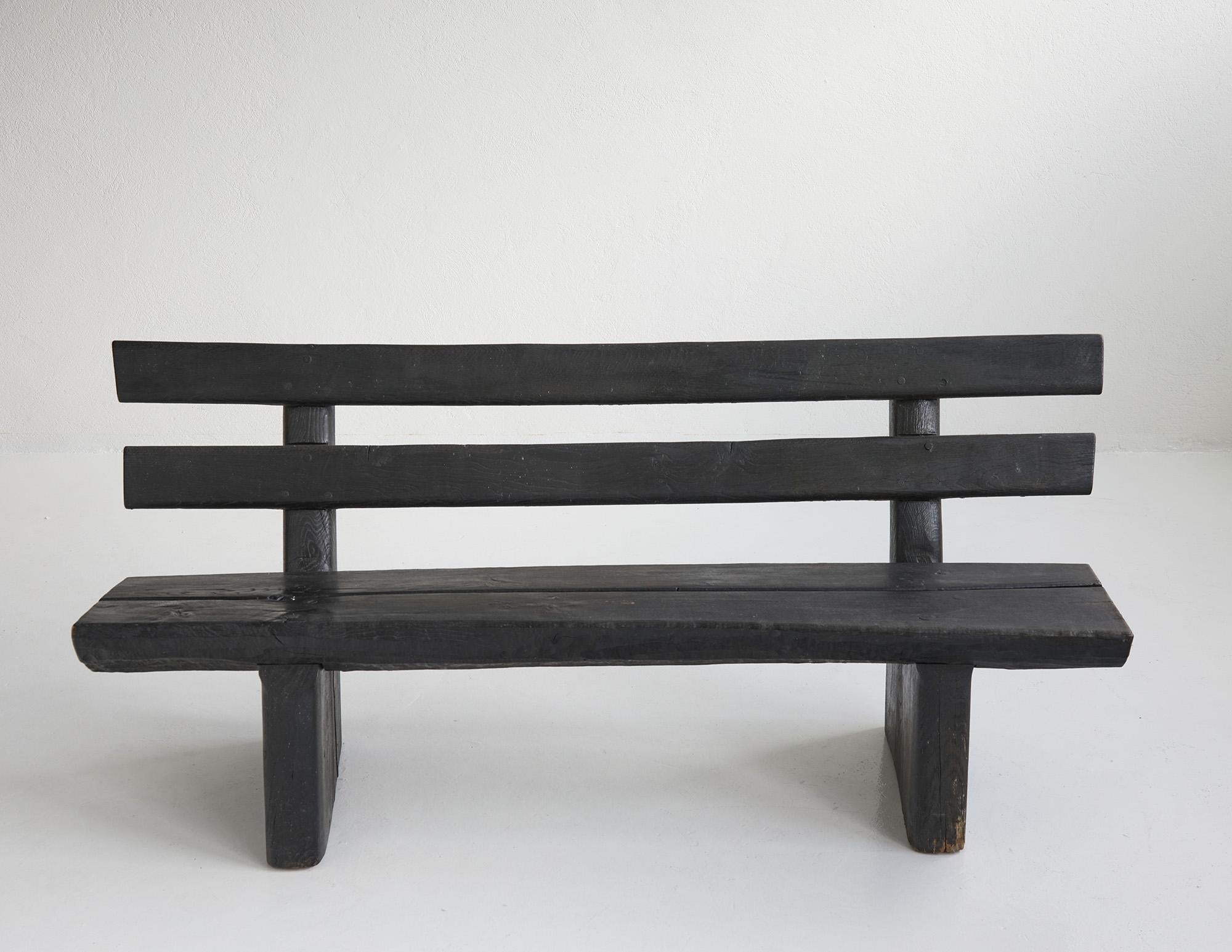 Blackened brutalist wood bench by Gottfried Anliker, Switzerland around 1960.

This is a stunning long bench made entirely from blackened wood. Both sculptural and brutalist in its appearance the bench showcases the texture of the more than half a