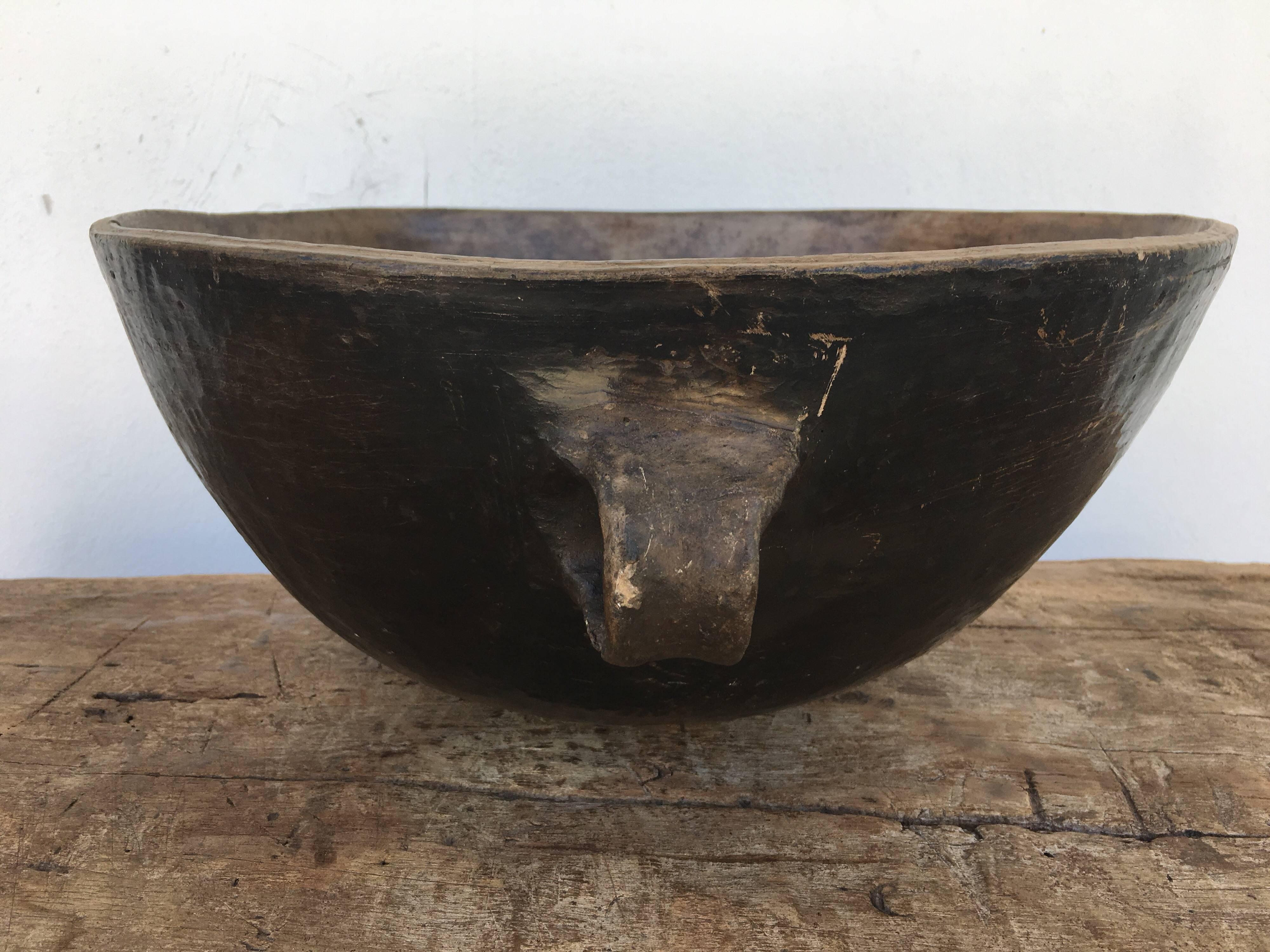 Blackened, primitive style serving bowl / cazuela from Los Reyes Metzontla, Puebla. The piece has been recently polished for sealing purposes. The vessel's handles and overall form are consistent with the designs of antiquity. The Popoloca culture