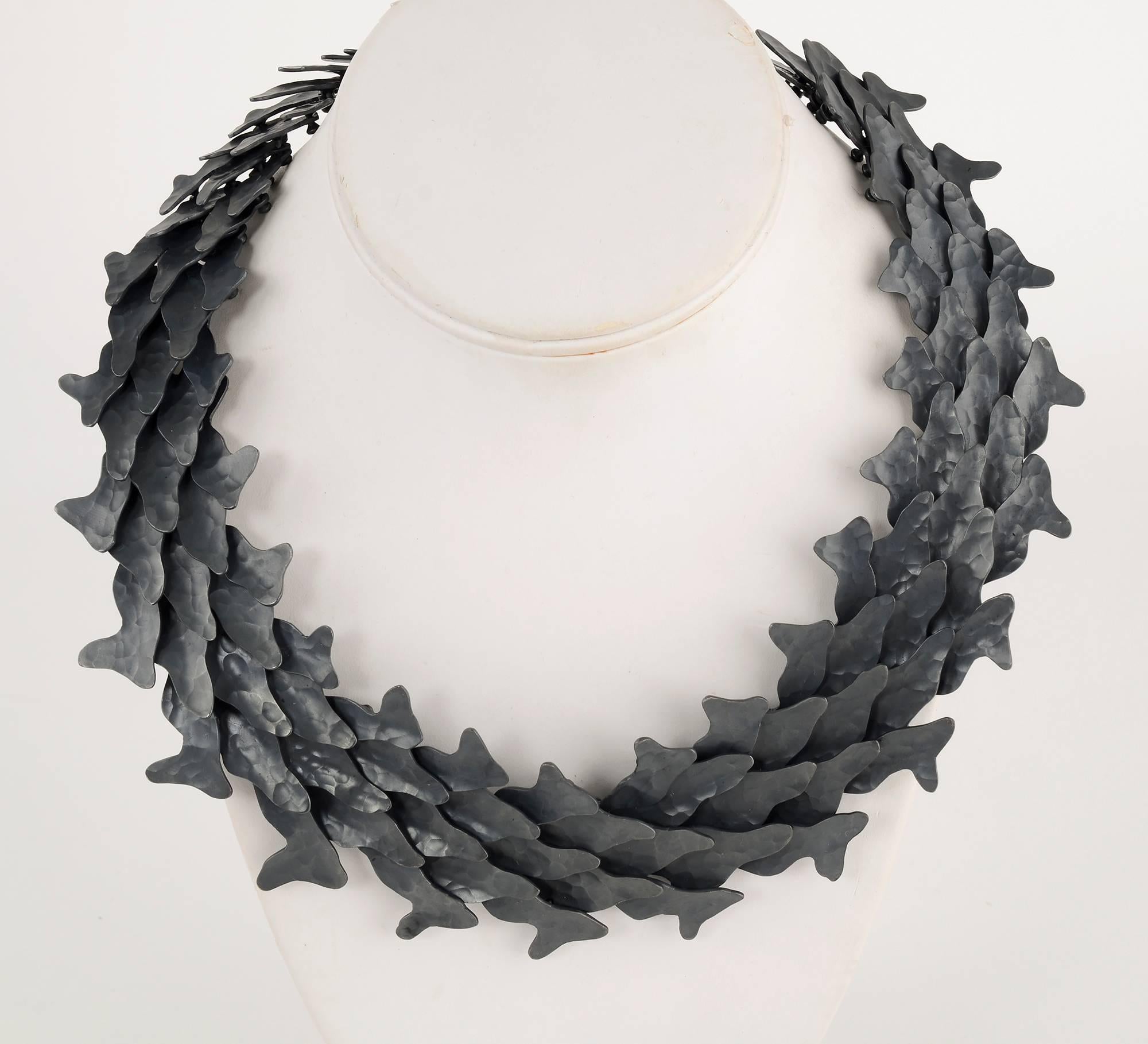 
Stunning hammered and oxidized silver necklace by Mexican designer, Eduardo Herrera. Herrera's experience as an architect is evident in the masterful creation of a necklace with overlapping links of varying shape and size to create a graceful form