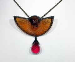 A Pressed Italian Glass and a Cultured Ruby Pendant set in Blackened Silver