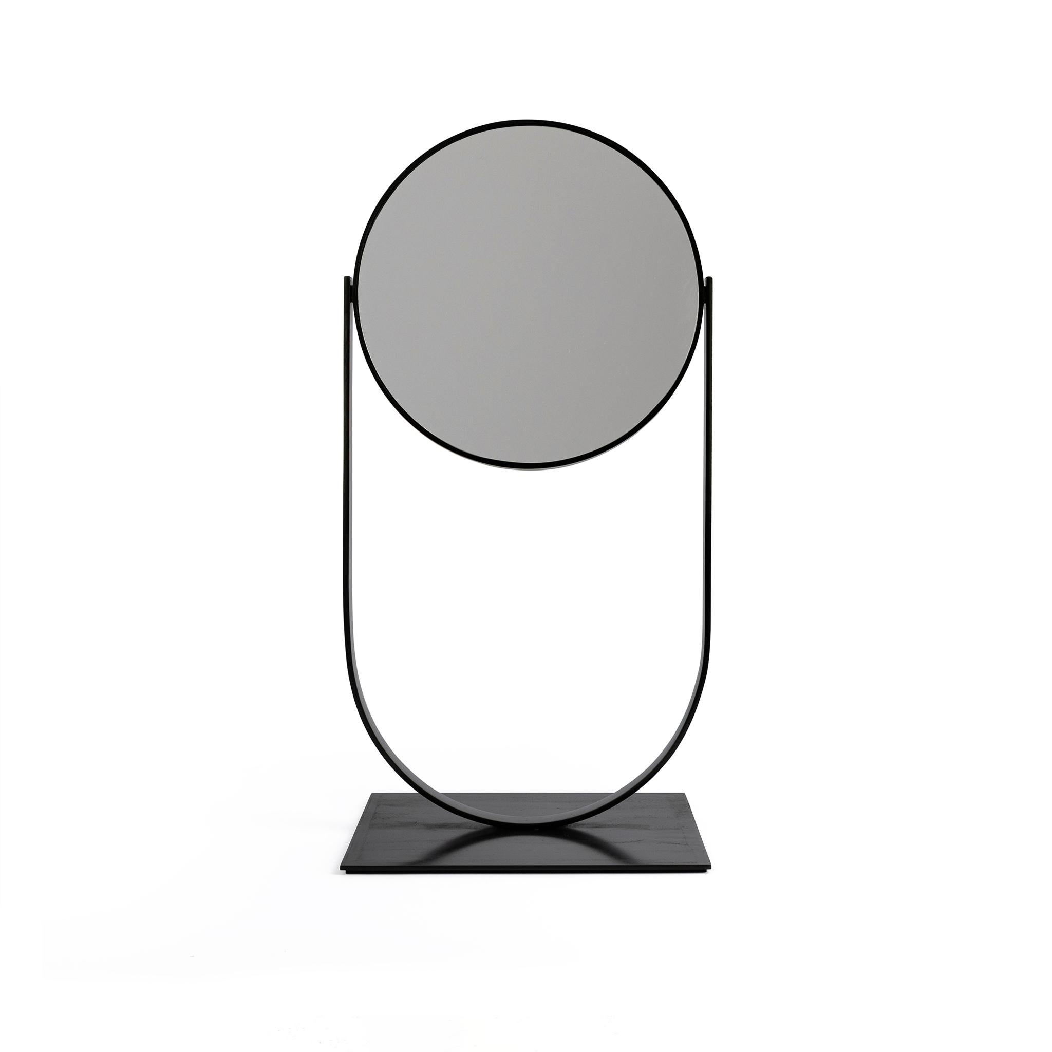 The Slate mirror is a simple and stylish yet durable and heavy table top mirror. It is perfect for any vanity or retail store setting. It is a contemporary vanity accessory built to last, fabricated and hand finished with a clean, blackened patina.