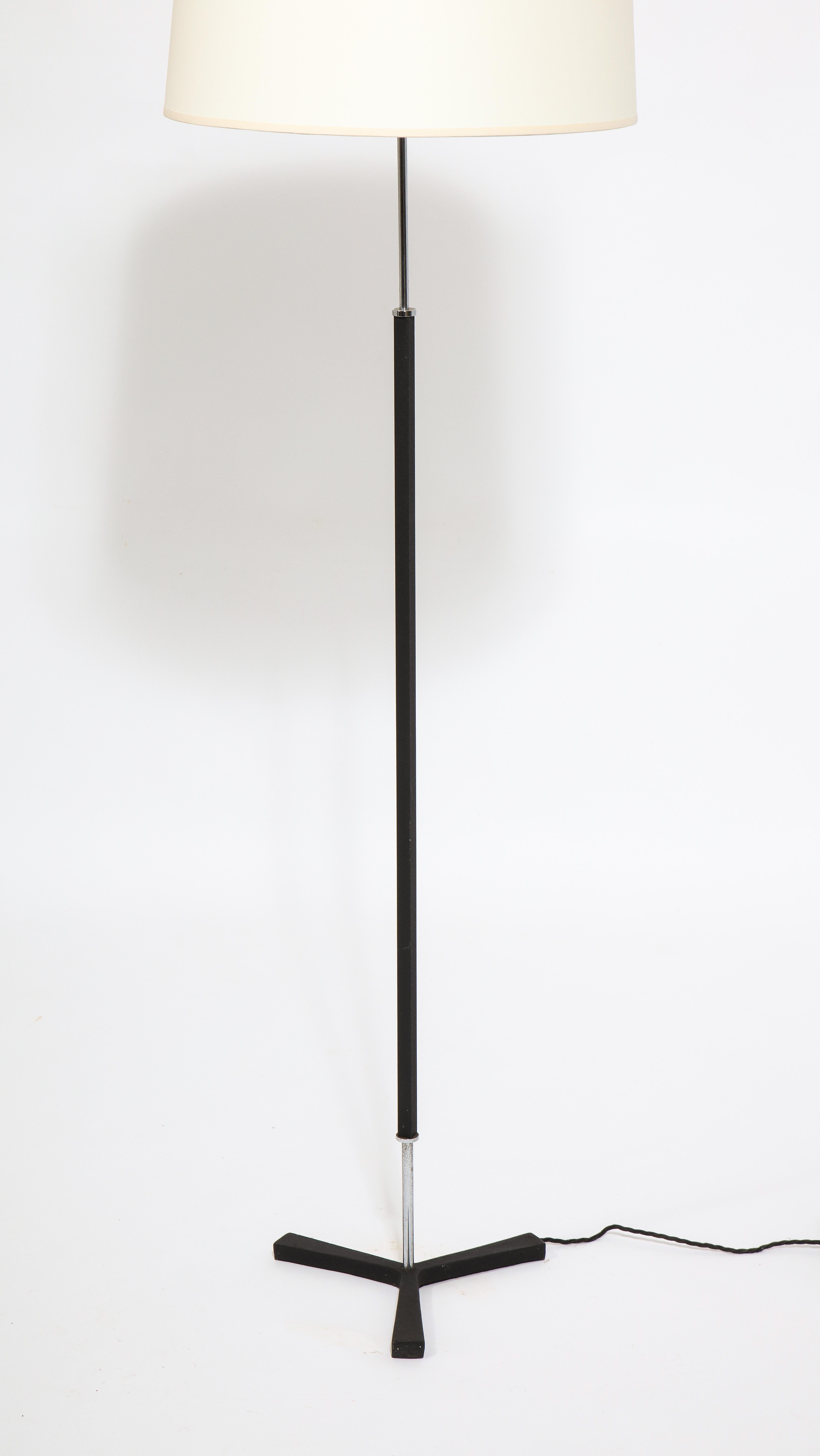 A minimal tripod floor lamp in blackened and chromed steel. Lampshade not included.