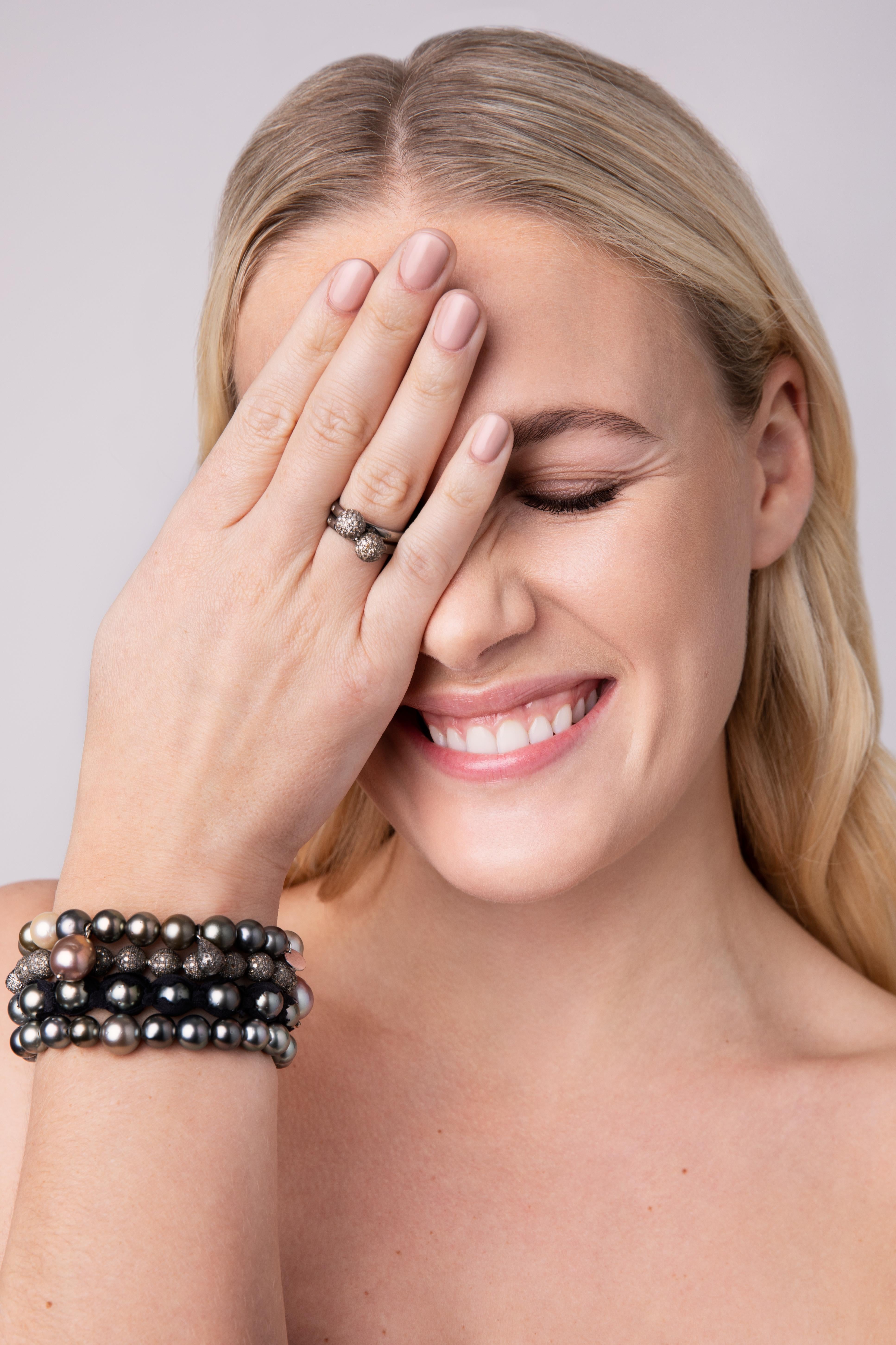 This ring is a new take on a classic. Inspired by an armor, the silver is black rhodium plated and the diamonds have a modern silver-ish color, set pavé on the dome and all around the ring.


