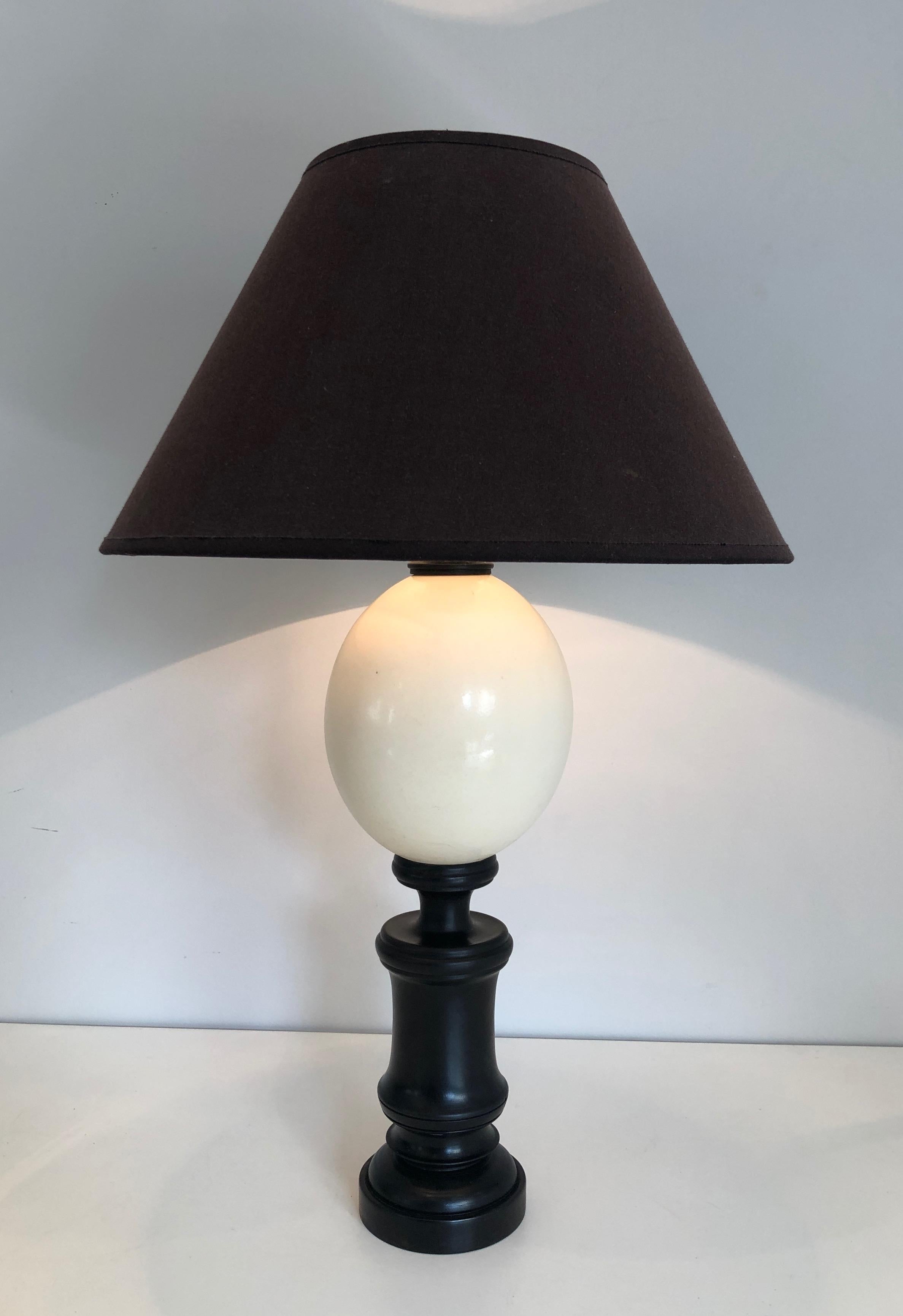This blackened table lamp is made of wood and ostrich eggshell. This is a French Work. Circa 1970.