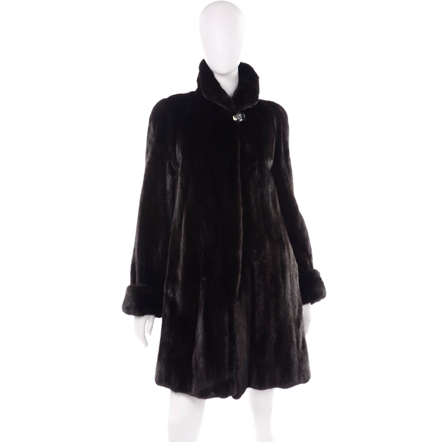 Vintage 1990s dark ranch, black mink fur coat from Blackglama, with a gorgeous adjustable collar. The collar can be formed at the front to be worn completely up, down, or slightly up! It has a large button at the neck, and three hinged metal